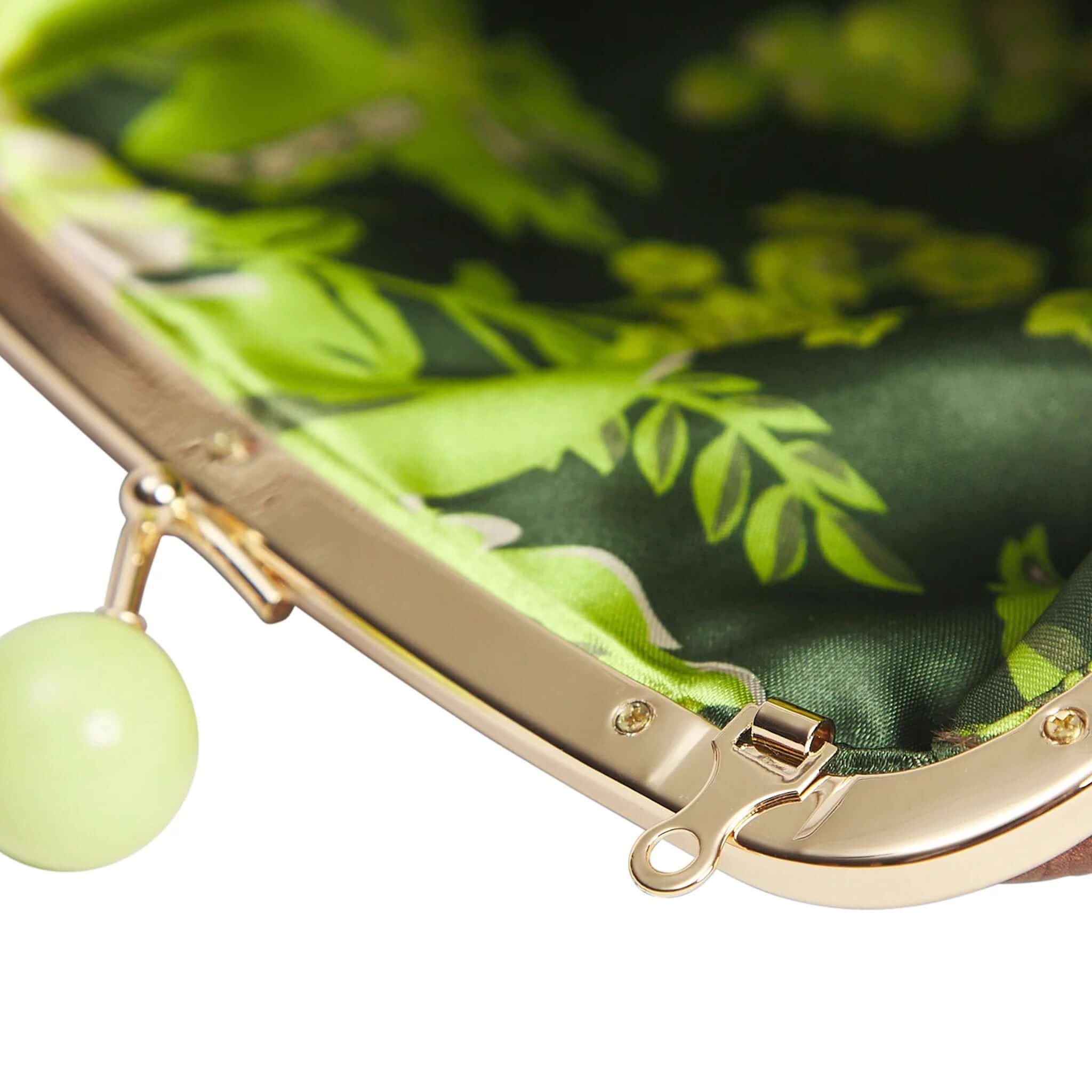 Interior design of Sage x Clare Bonny Large Purse - Umber with green floral pattern and gold kisslock frame.