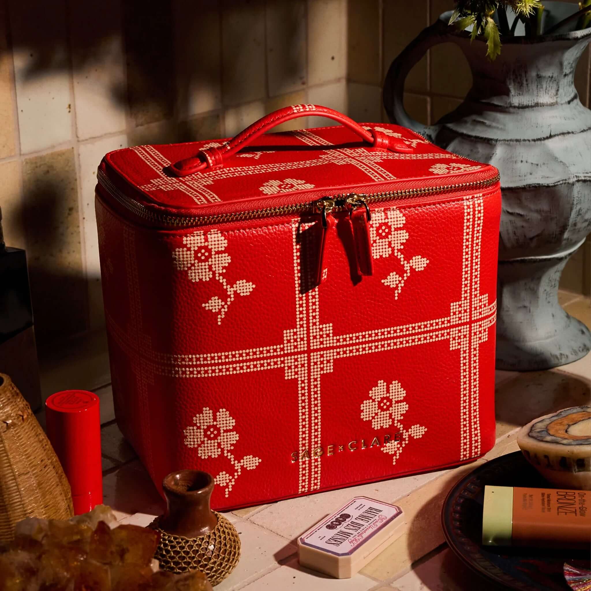 Sage x Clare Bonny Medium Vanity Case - Poppy showcased on a countertop with beauty essentials.