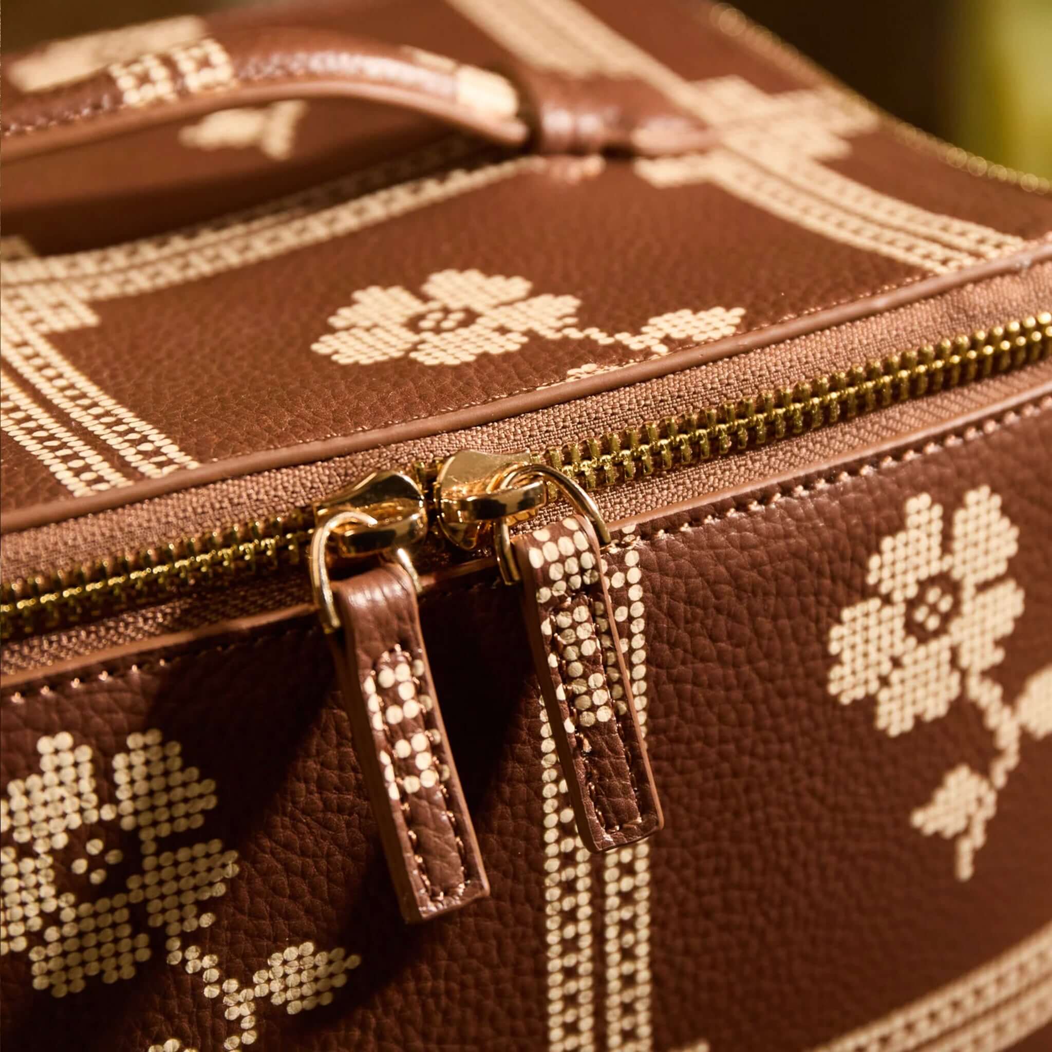 Sage x Clare Bonny Medium Vanity Case - Umber with gold zip hardware and floral design in close-up.