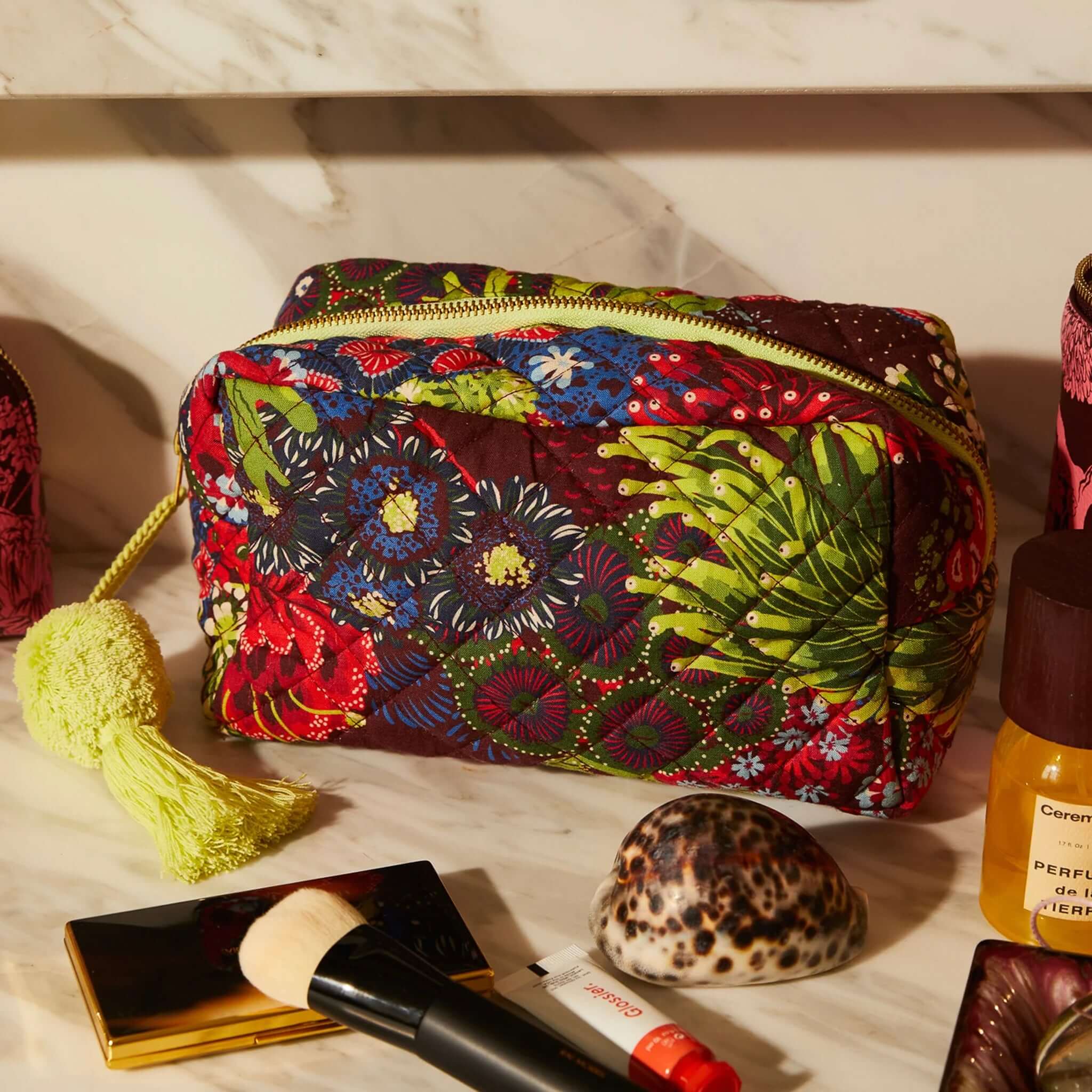 Sage x Clare Cora Organic Cotton Beauty Bag in vibrant floral print with lime green tassel zip pull.