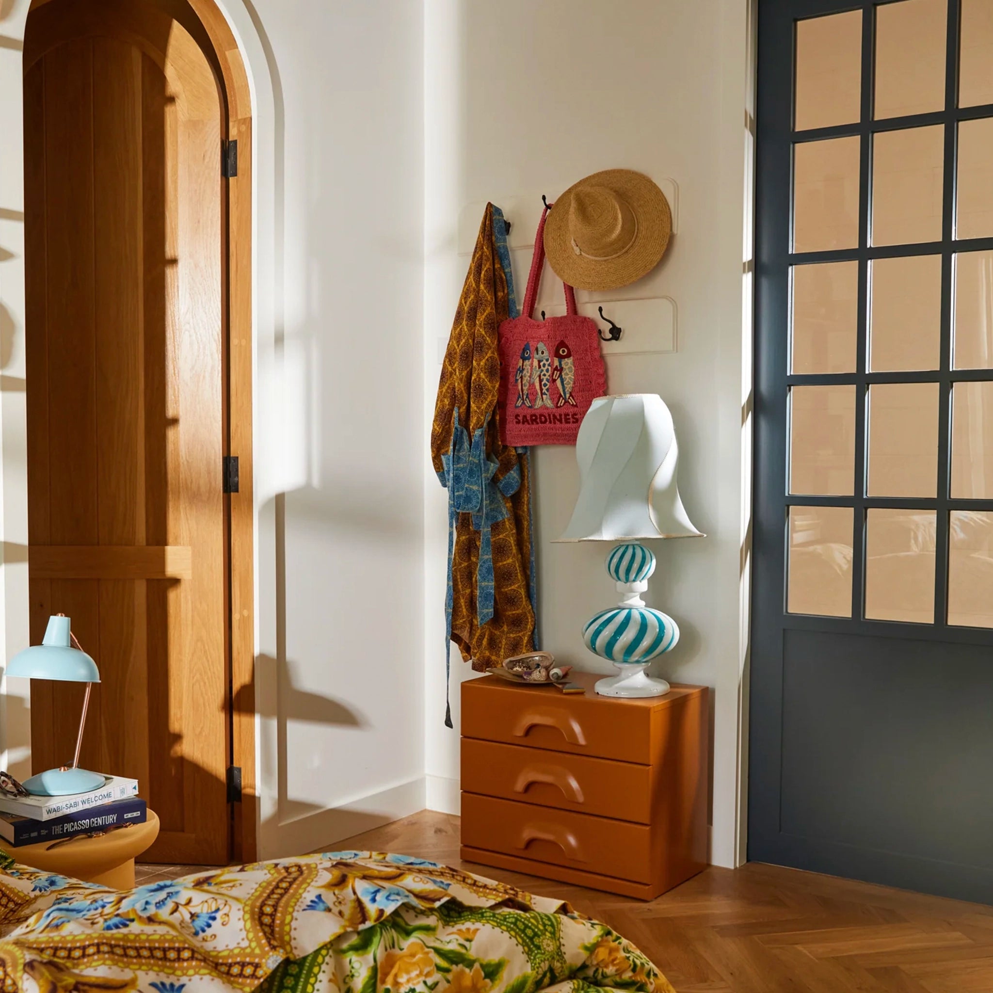 Nestled corner of a room with wooden furniture, decorative items, and a lamp.