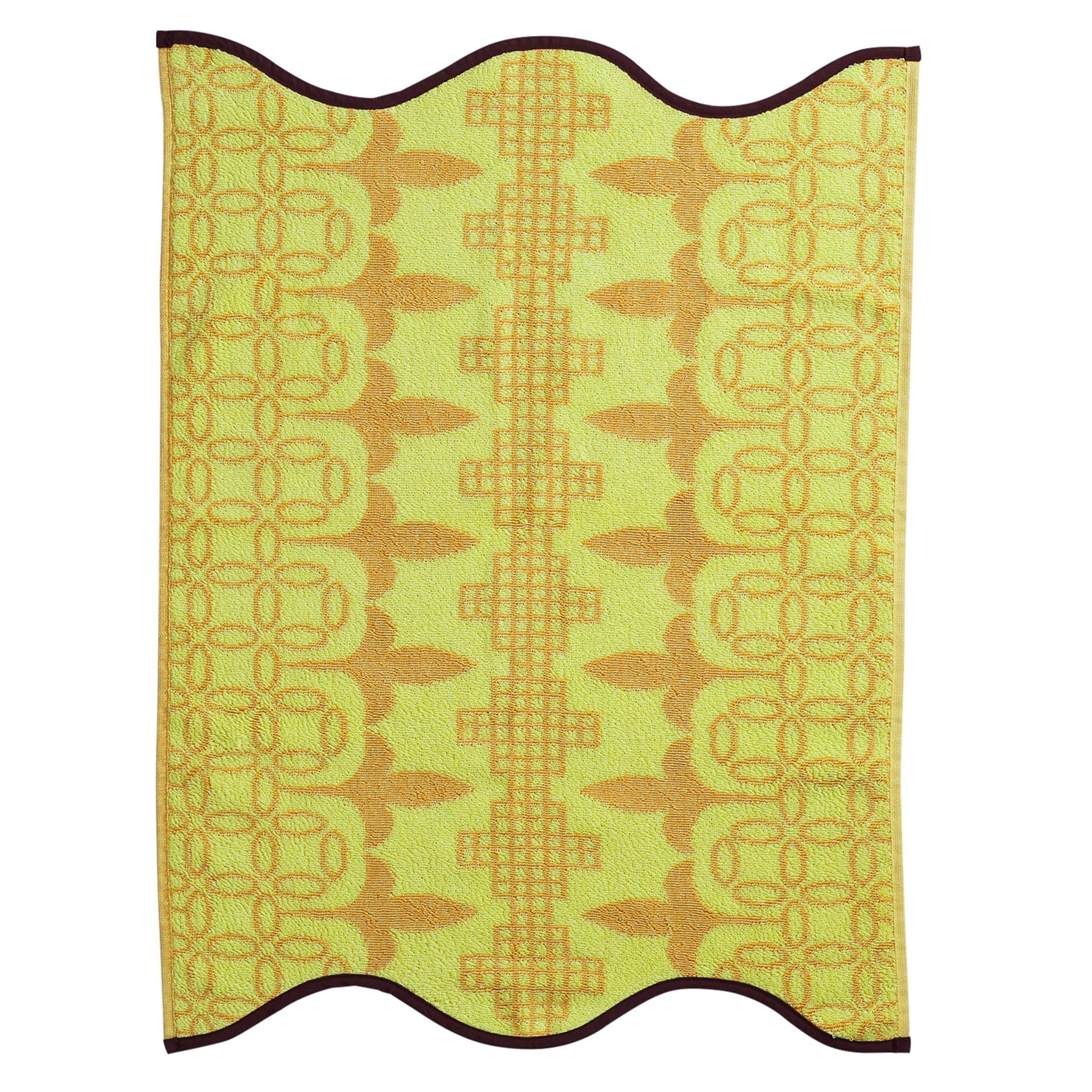 Yellow textured hand towel with leaf pattern on a white background