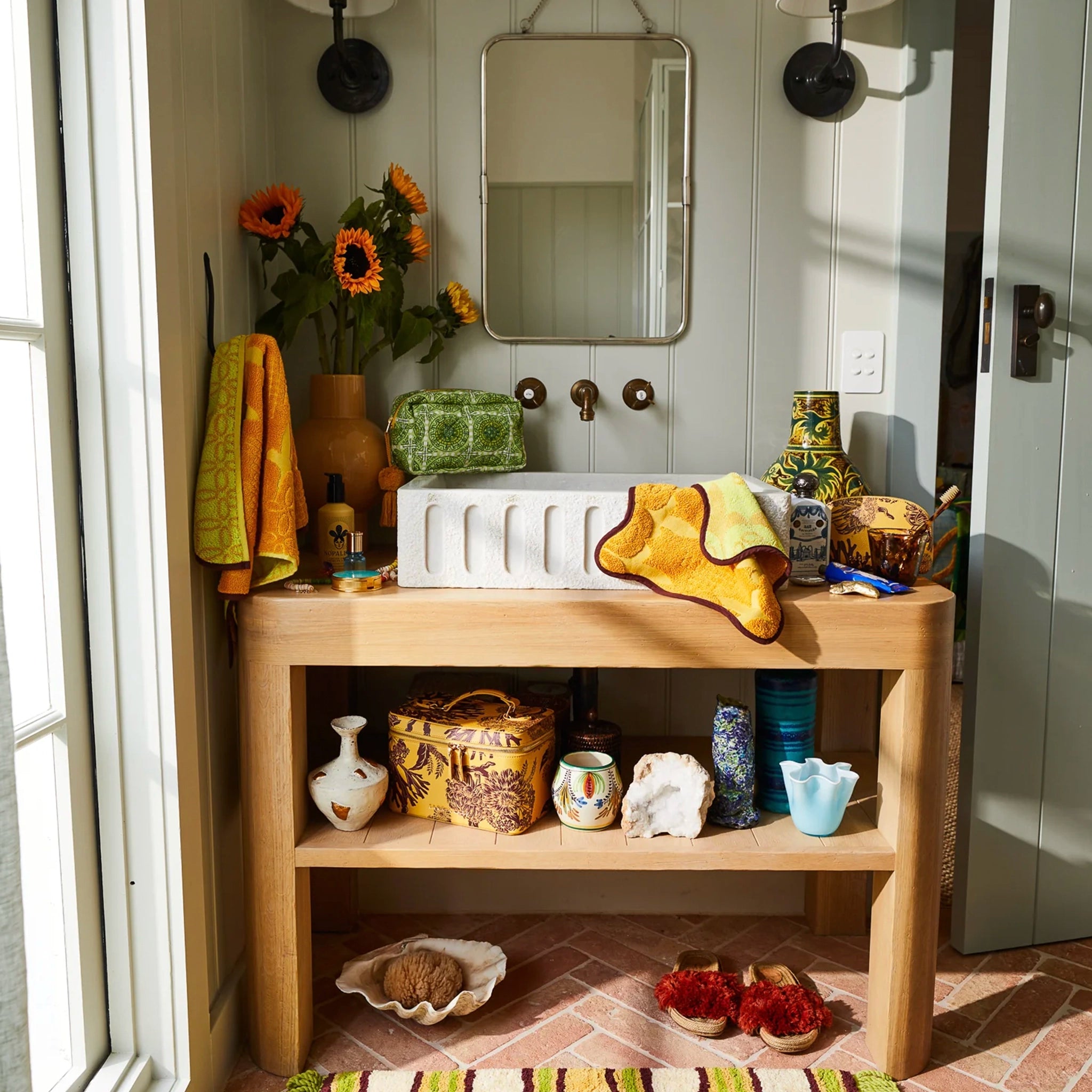 Bathroom vanity with decorative items and a mirror
