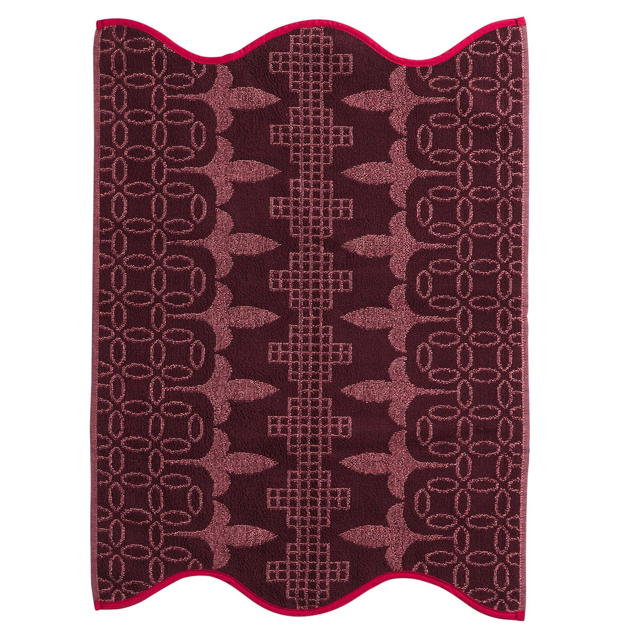 Pink hand towel with decorative pattern on a white background