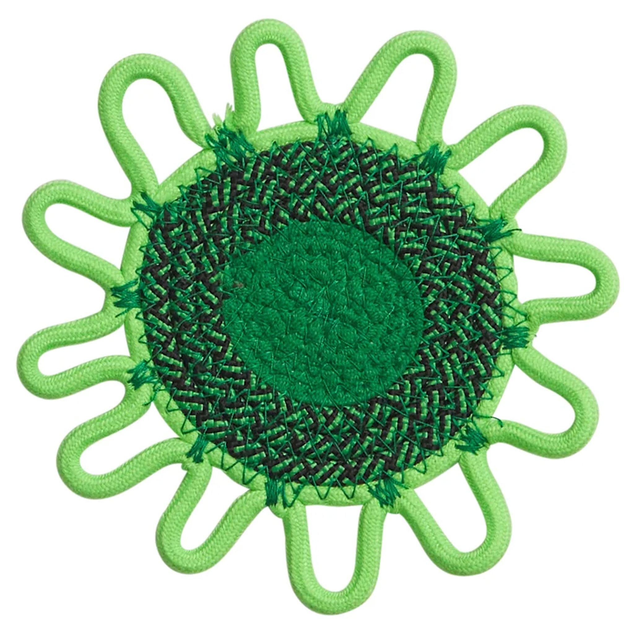 Green sun-shaped coaster with textured center on a white background