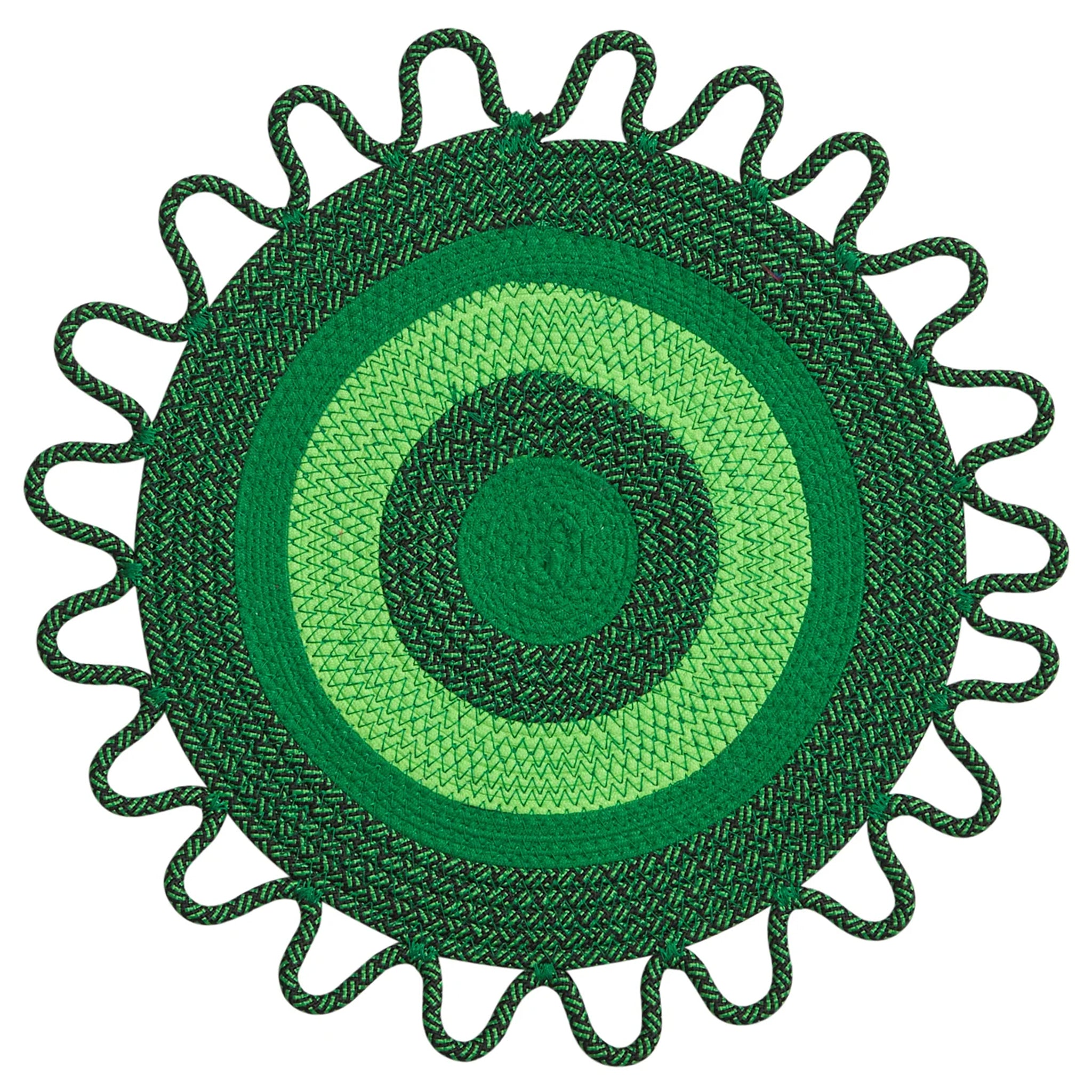 Green circular placemats with a texture on a white background