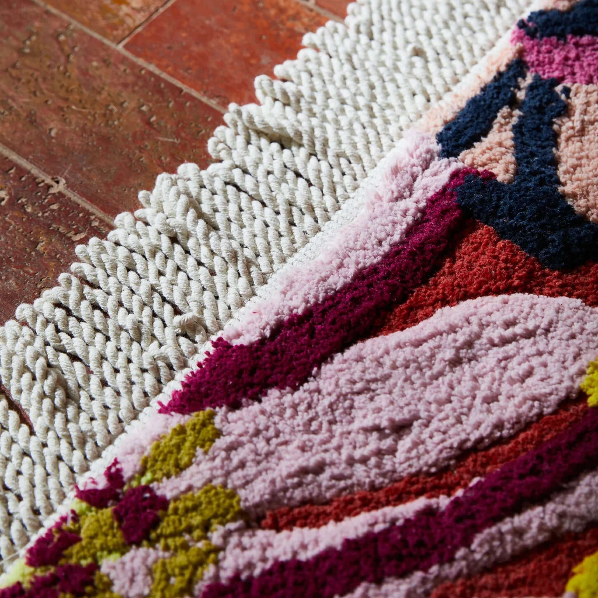 Alt Tag: Sage x Clare Ines Bath Mat close-up, plush GOTS organic cotton bath mat with bold floral pattern and braided edge