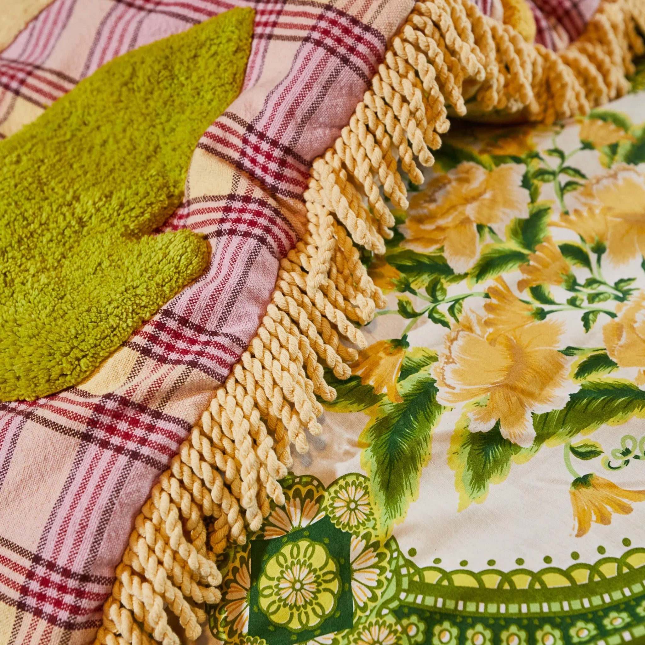 Close-up of a patchwork quilt with floral and plaid patterns.