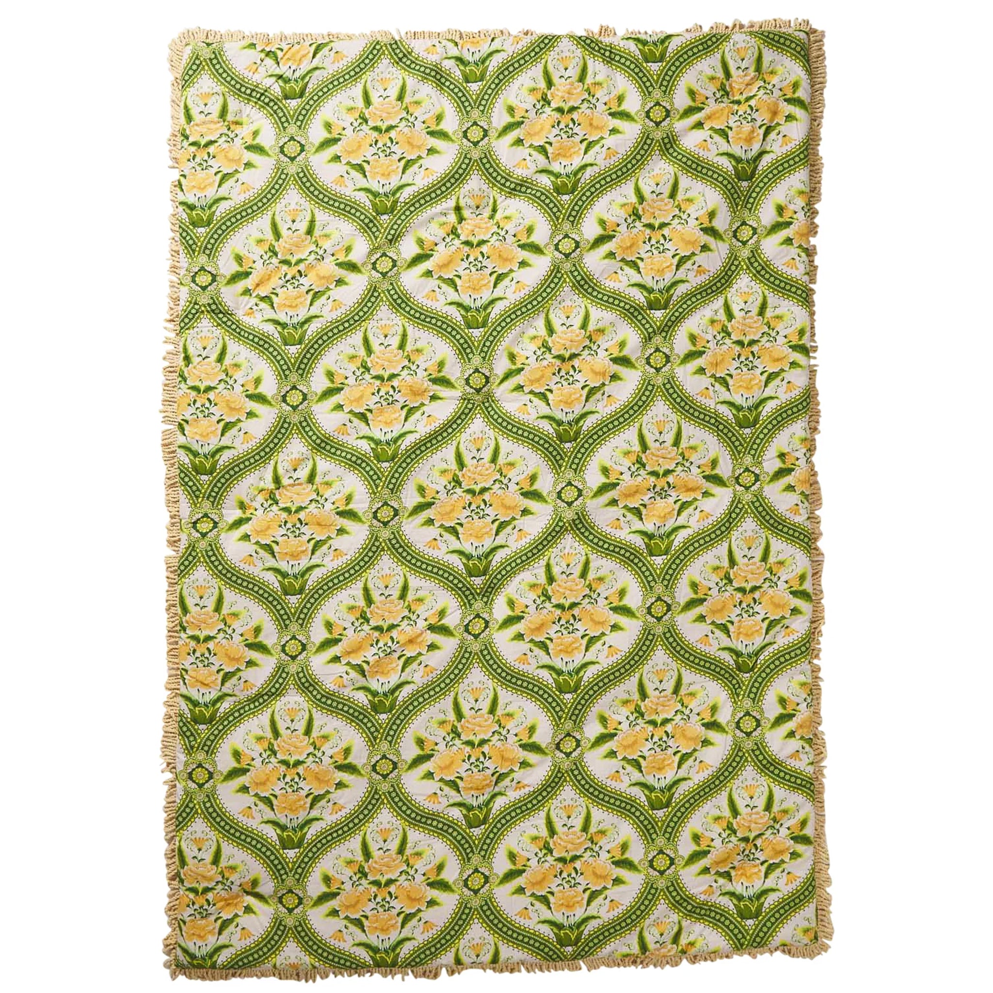 Floral patterned quilt with green and yellow design on a white background