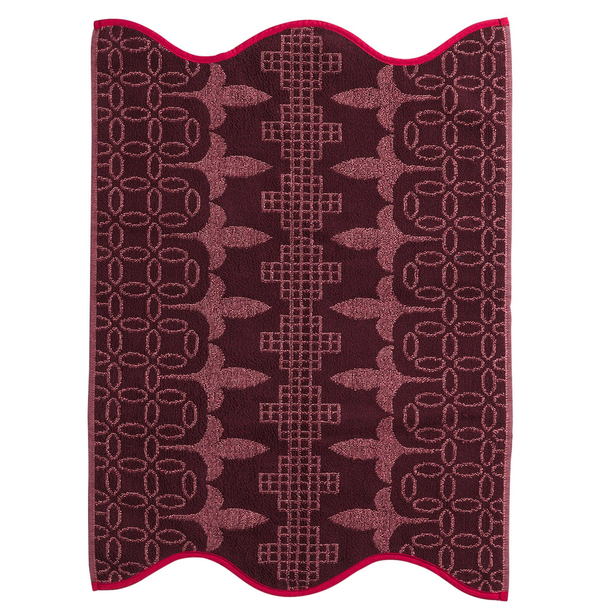 Floral patterned hand towel with fringes on a white background