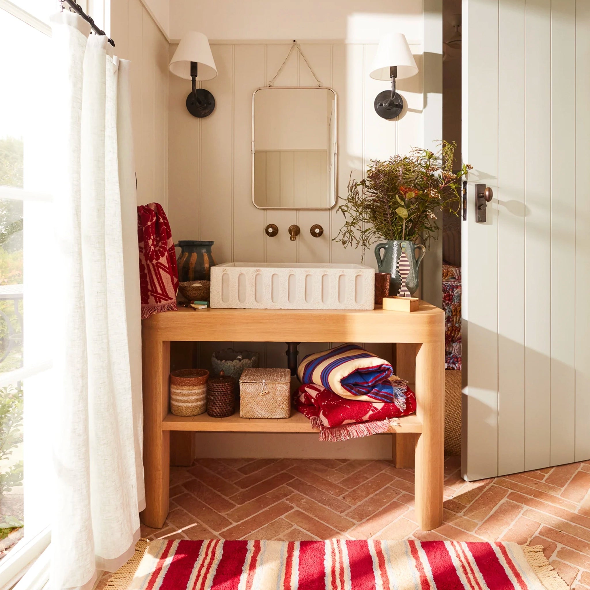 Bathroom with wooden vanity, sink, and decorative elements.