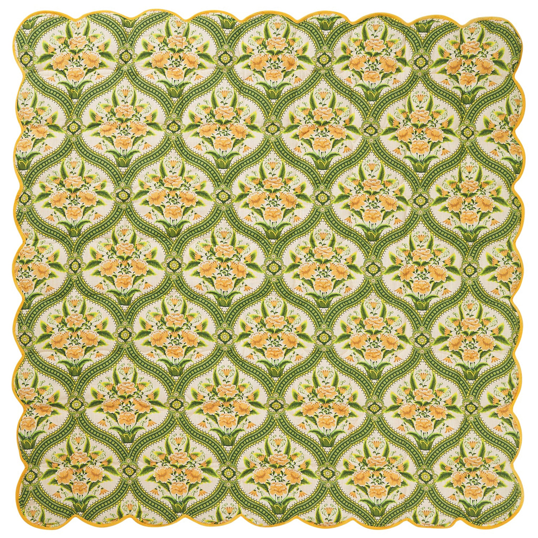 Decorative quilt with floral pattern on a green background