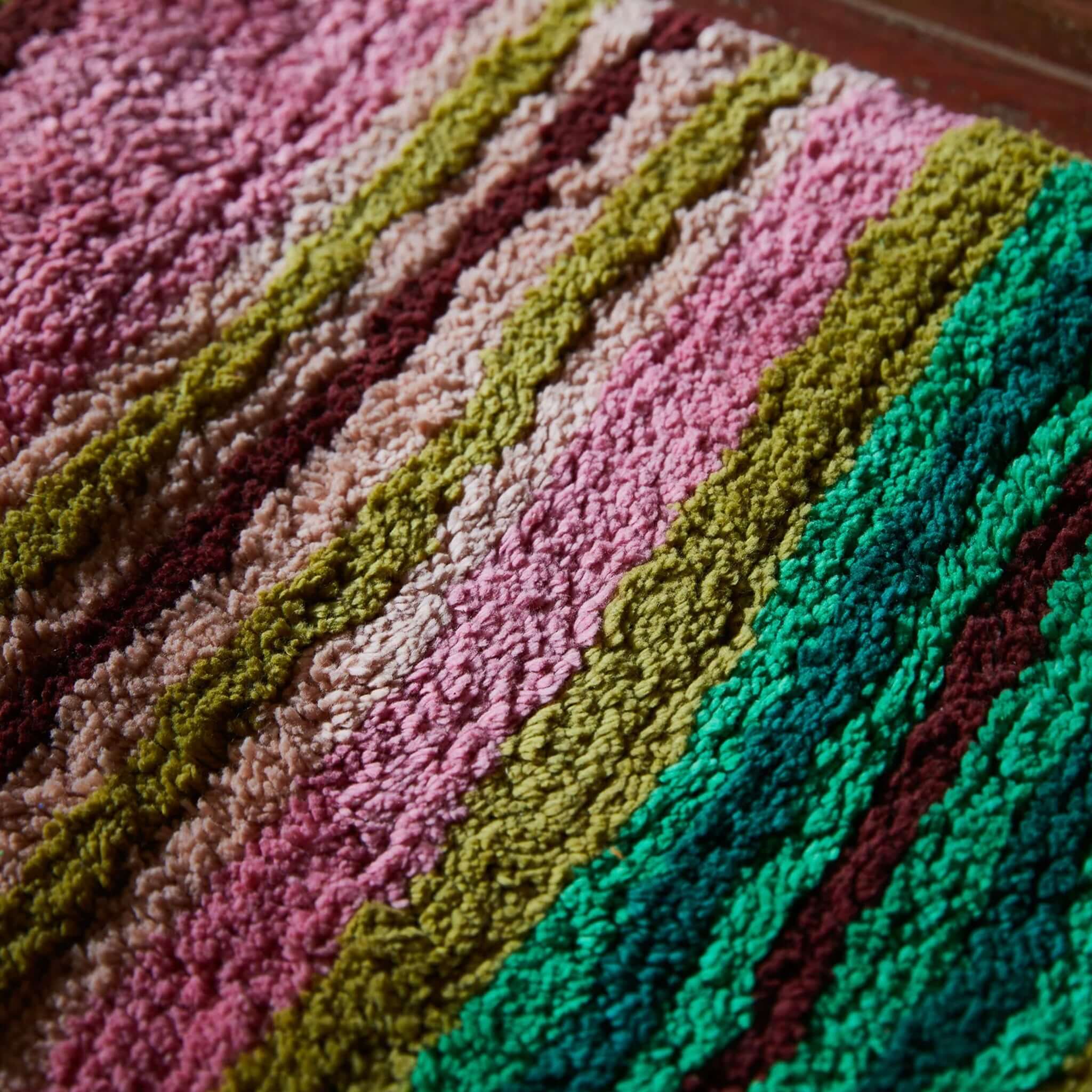 Sage x Clare Nicolette Bath Runner vibrant multicolour stripes of pink, green, olive, yellow, and orange.