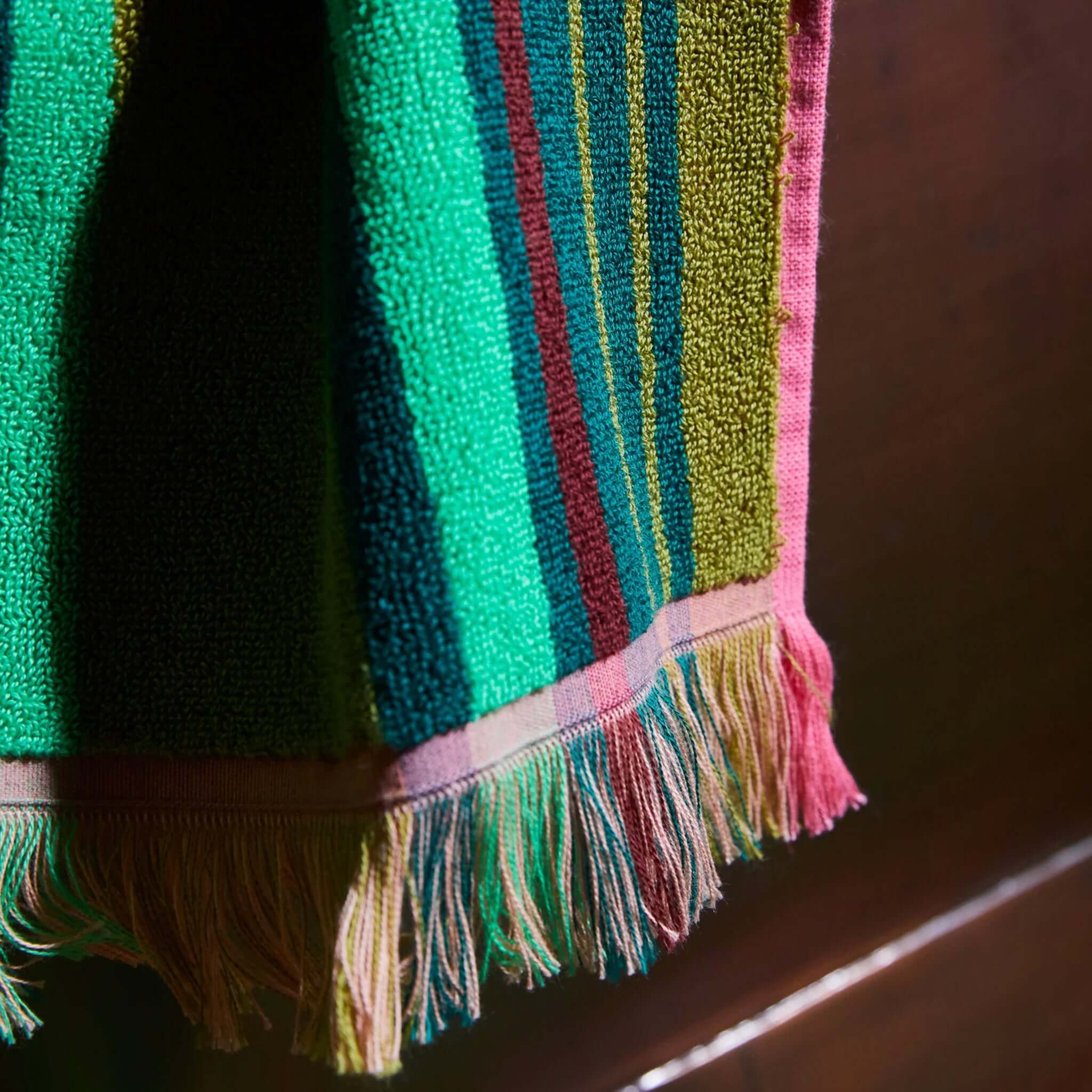 Alt Tag: Sage x Clare Nicolette Hand Towel - Juniper close-up of plush terry stripes in green, teal and pink with fringed edge