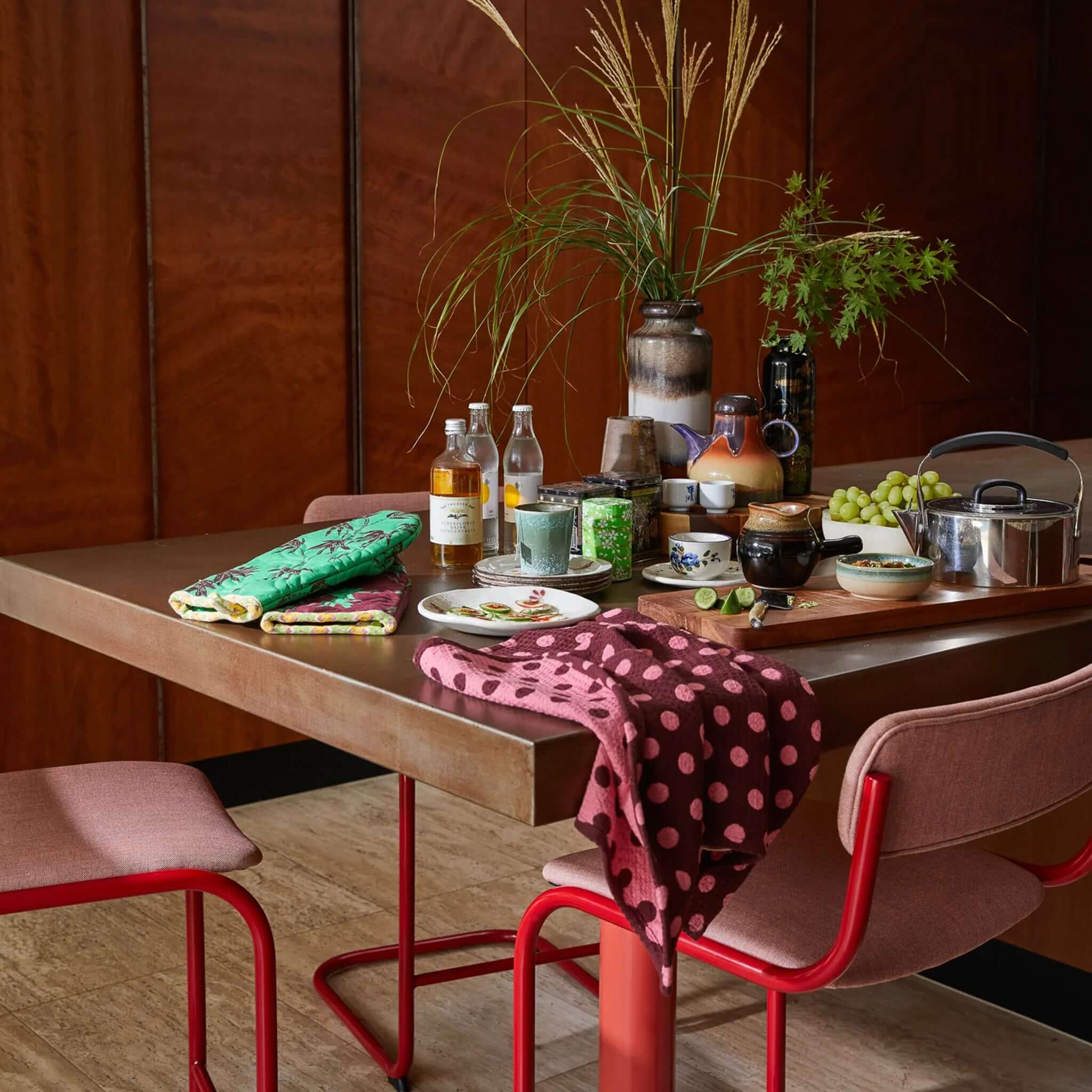 Alt Tag: Sage x Clare Paige Organic Cotton Tea Towel - Rosewood draped on dining table, deep red spot waffle weave organic cotton, absorbent kitchen towel