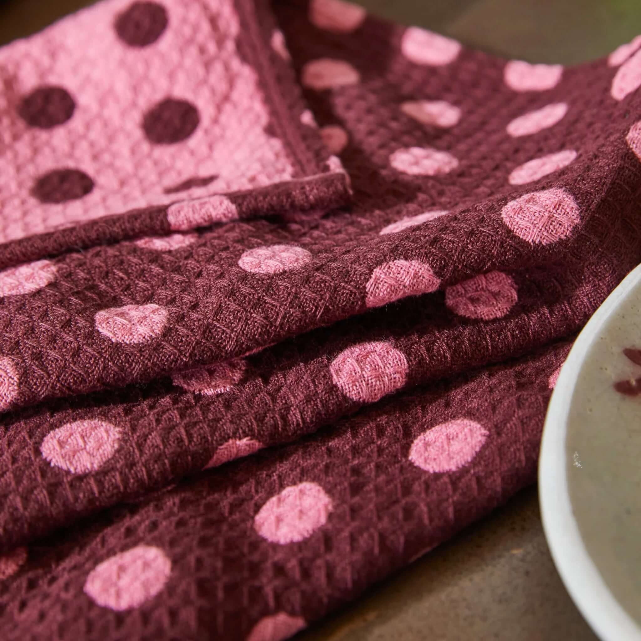 Alt Tag: Sage x Clare Paige Organic Cotton Tea Towel - Rosewood waffle weave rosewood spot tea towel with pink dots, absorbent kitchen linen