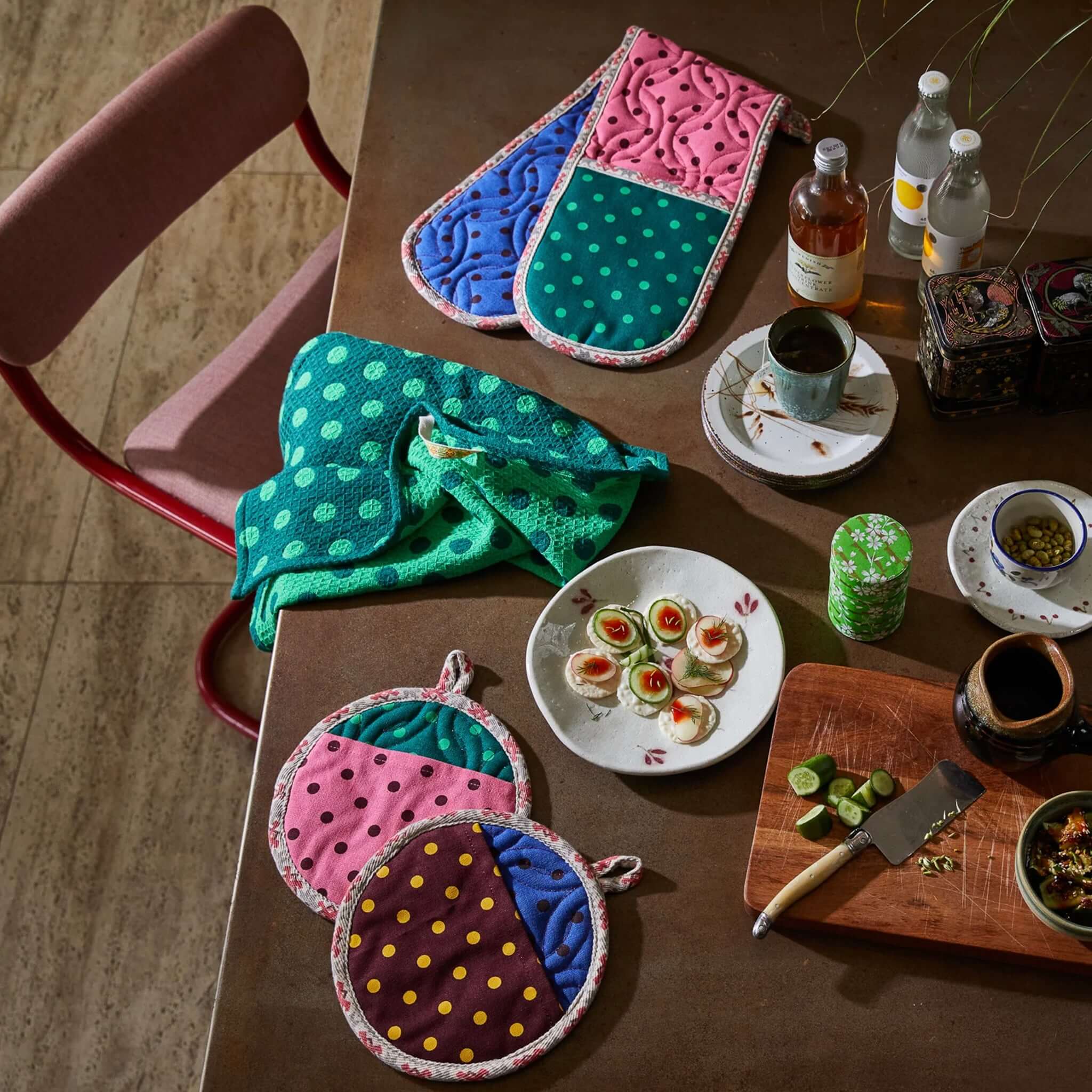 Alt Tag: Sage x Clare Paige Organic Cotton Tea Towel - Verdant green spot waffle weave tea towel styled on kitchen table with colourful cookware