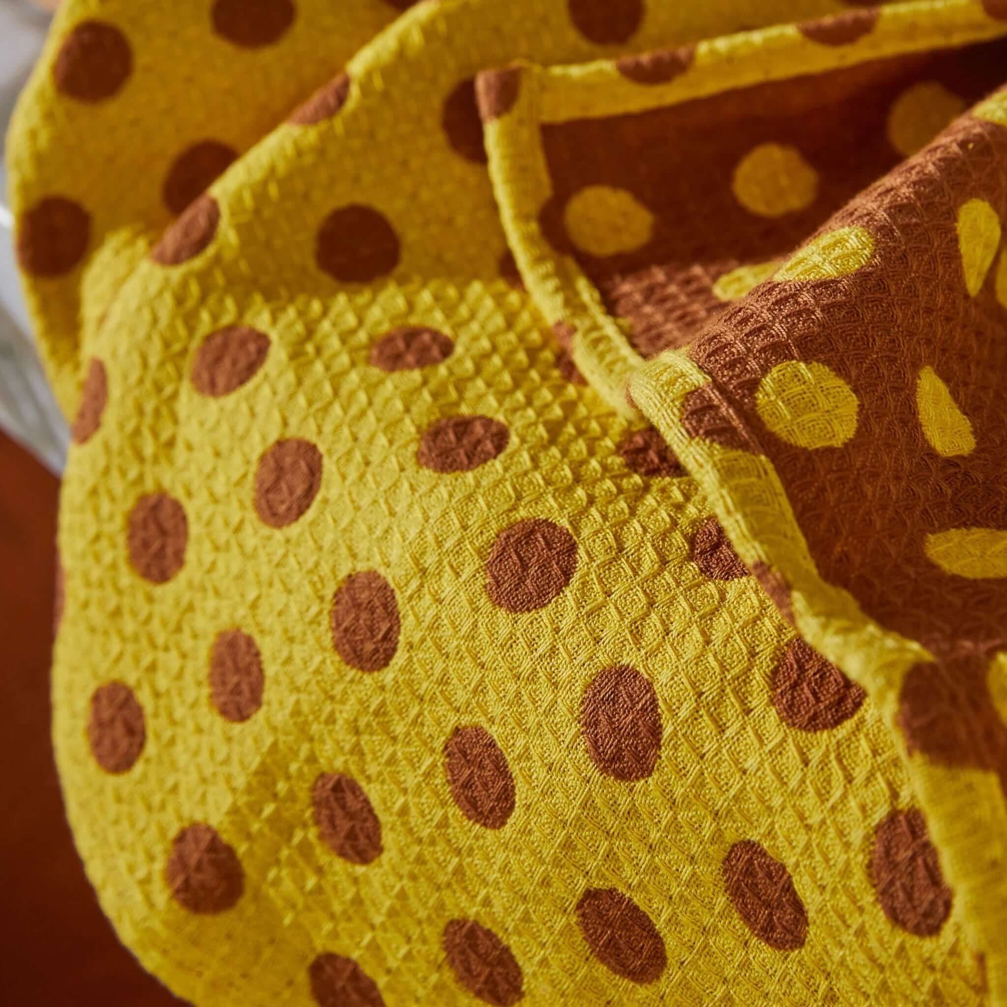 Alt Tag: Sage x Clare Paige Organic Cotton Tea Towel - Medallion bright yellow waffle weave tea towel with playful brown spots, absorbent