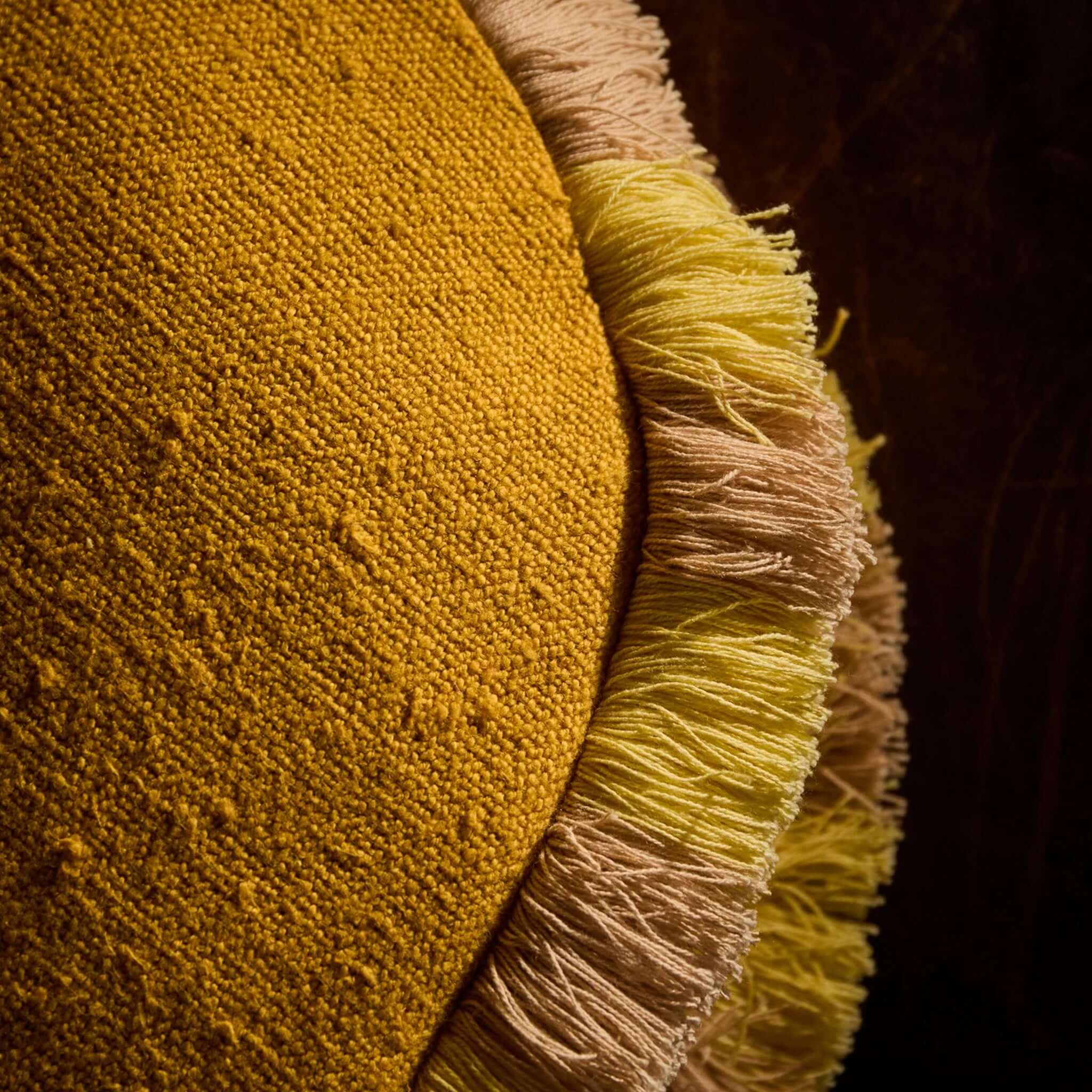 Sage x Clare Reese Round Cushion - Ochre featuring textured ochre fabric with lemon and blush fringe detailing.