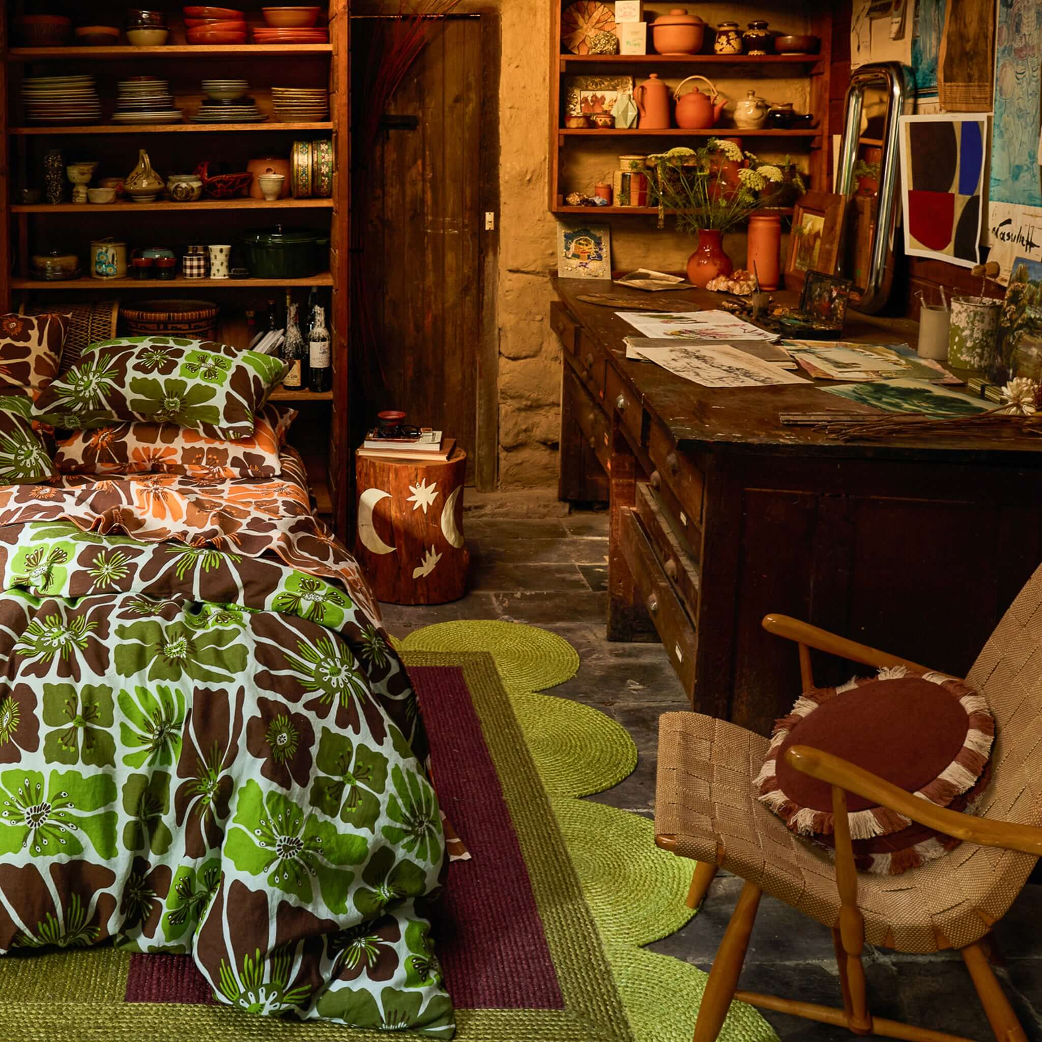 Cozy bedroom featuring Sage x Clare Reese Round Cushion - Umber with floral bedding and rustic decor.