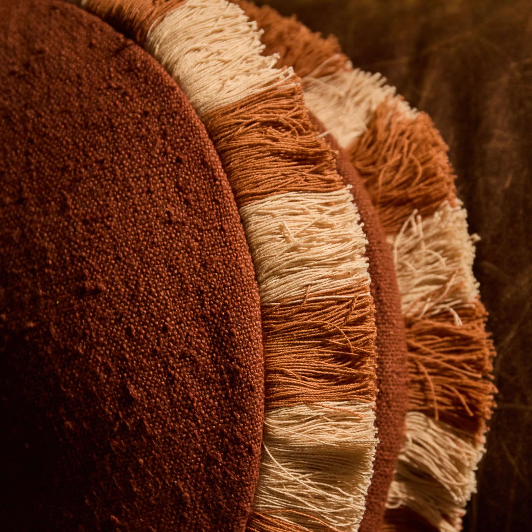 Sage x Clare Reese Round Cushion - Umber featuring textured umber fabric and playful rust and cream fringe.