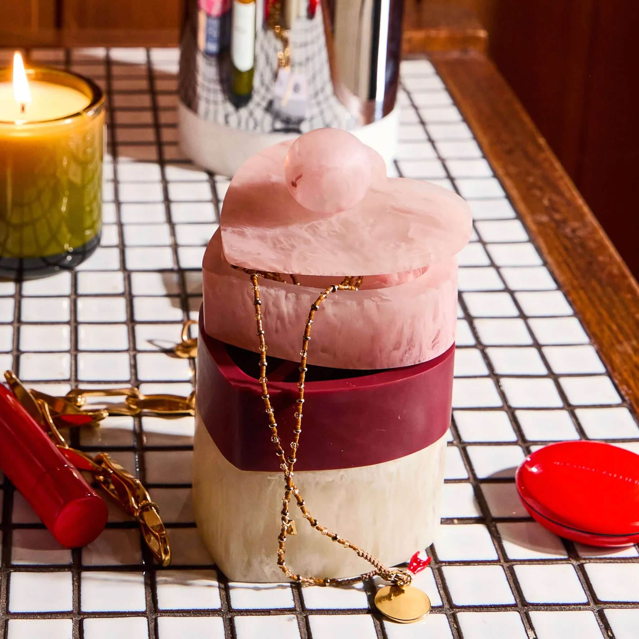 Sage x Clare Resin Harmony Stacking Jewelry Box Set - Orchid featuring heart-shaped tiers and jewelry on a tiled surface.