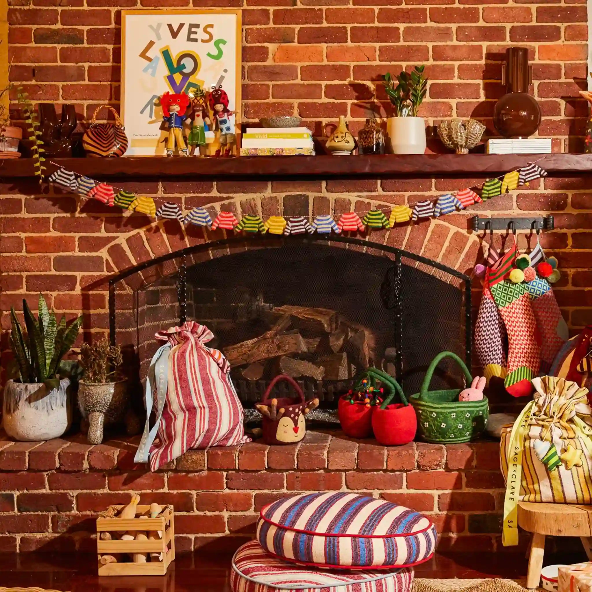 Decorative fireplace with various items including plants, a striped rug, and colorful decorations.