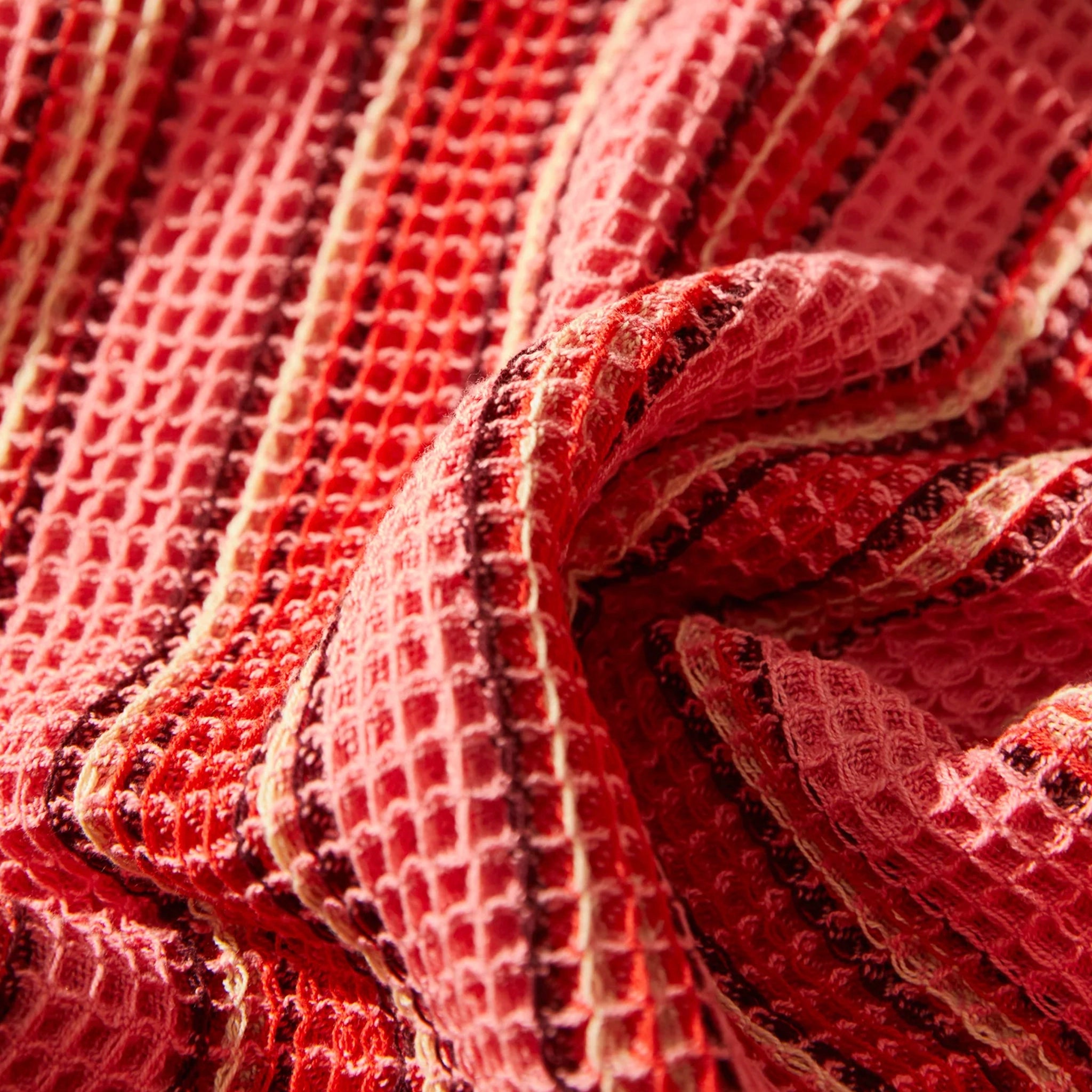 Close-up of textured red tea towel with a woven pattern