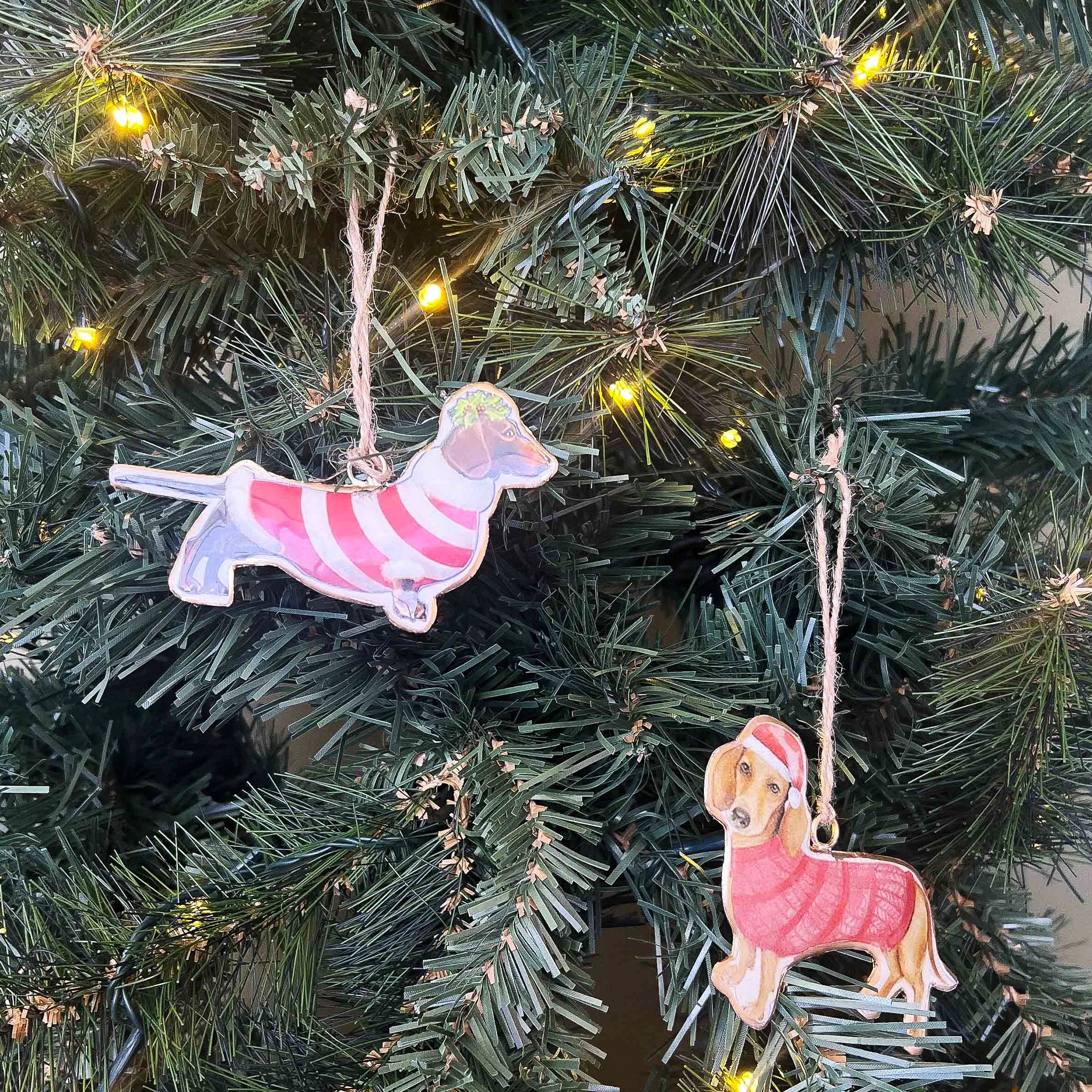 Decorative dog ornaments on a Christmas tree with lights.