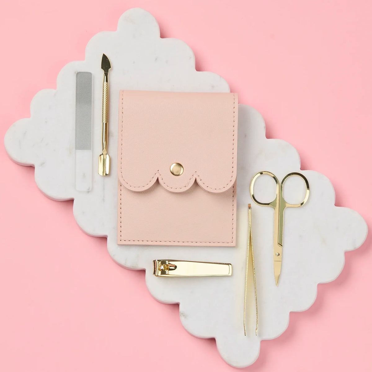 Selfie Nails Manicure Tool Kit - Nude, closed nude pouch beside gold nail tools and glass file