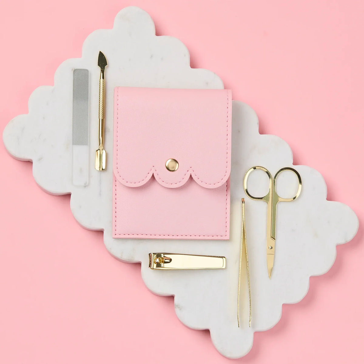 Selfie Nails Manicure Tool Kit - Pink, closed pink pouch beside gold nail tools and glass file