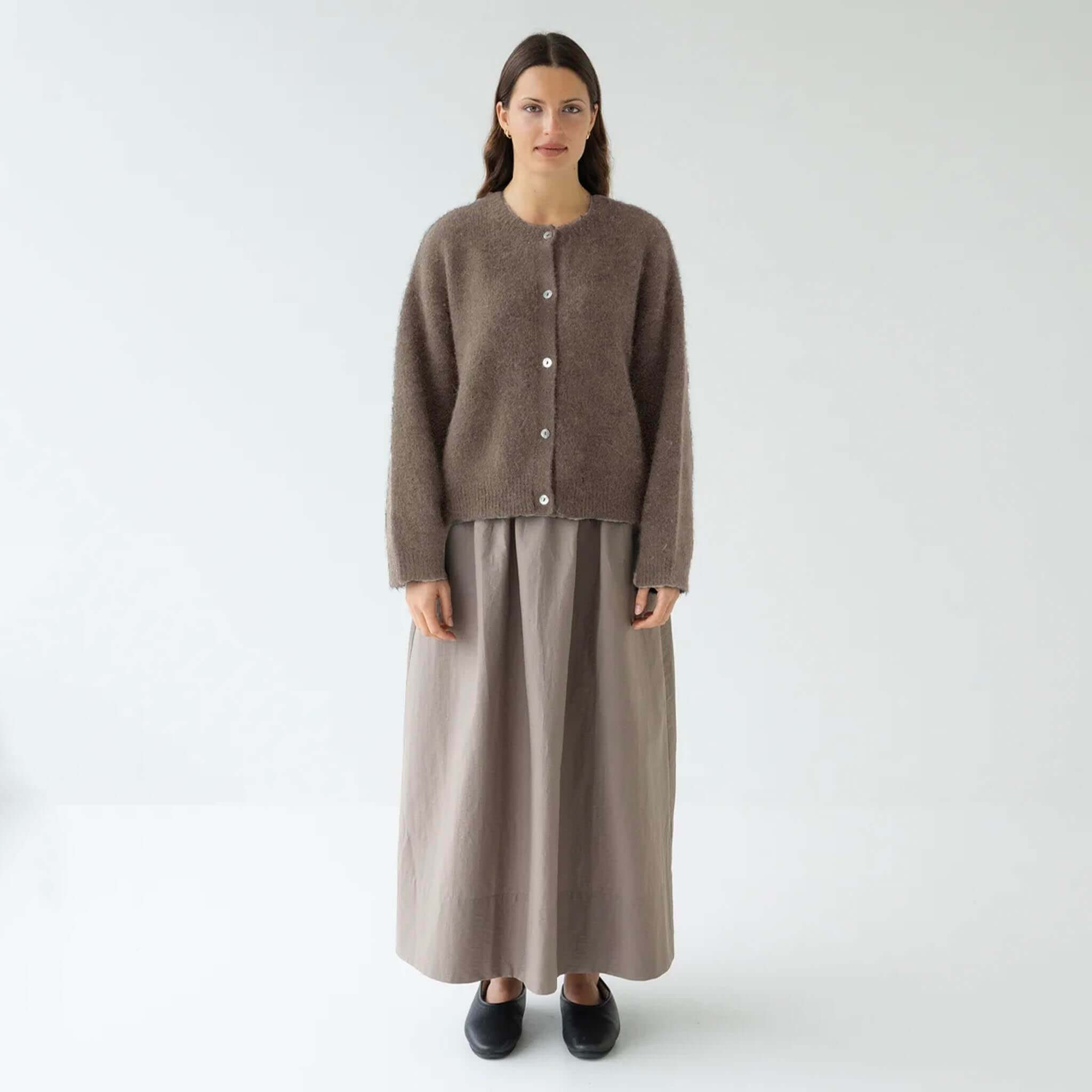 Sophie Alpaca & Merino Blend Cardigan - Walnut displayed on a model with a long skirt, offering a cozy and stylish look.