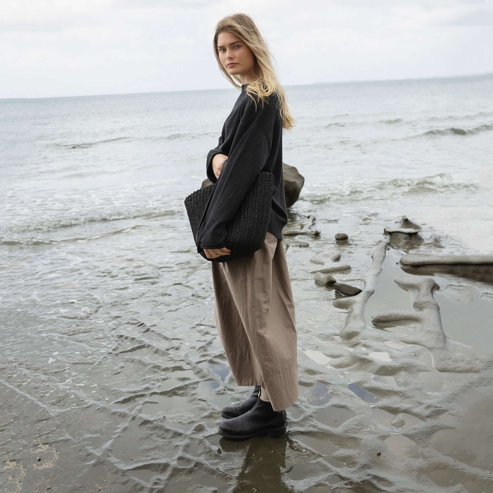 Alt Tag: Sophie Maxi Skirt - Fog worn by model on a rocky beach, relaxed drape with deep side pockets, breathable cotton-nylon maxi skirt