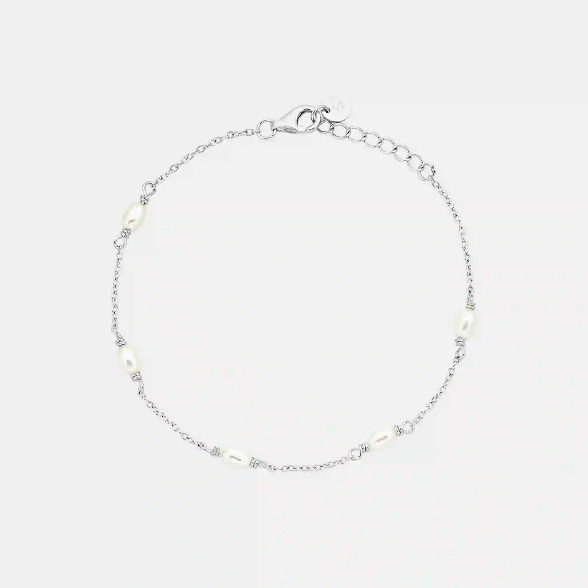 Silver bracelet with small stones on a light gray background