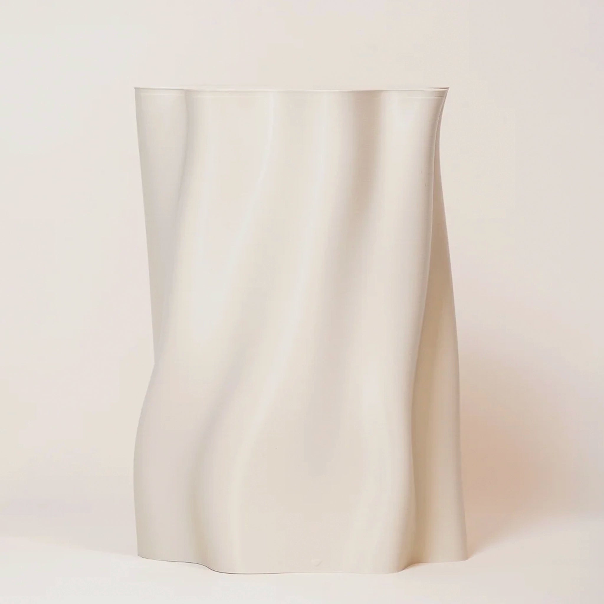 White ceramic vase on a light beige background