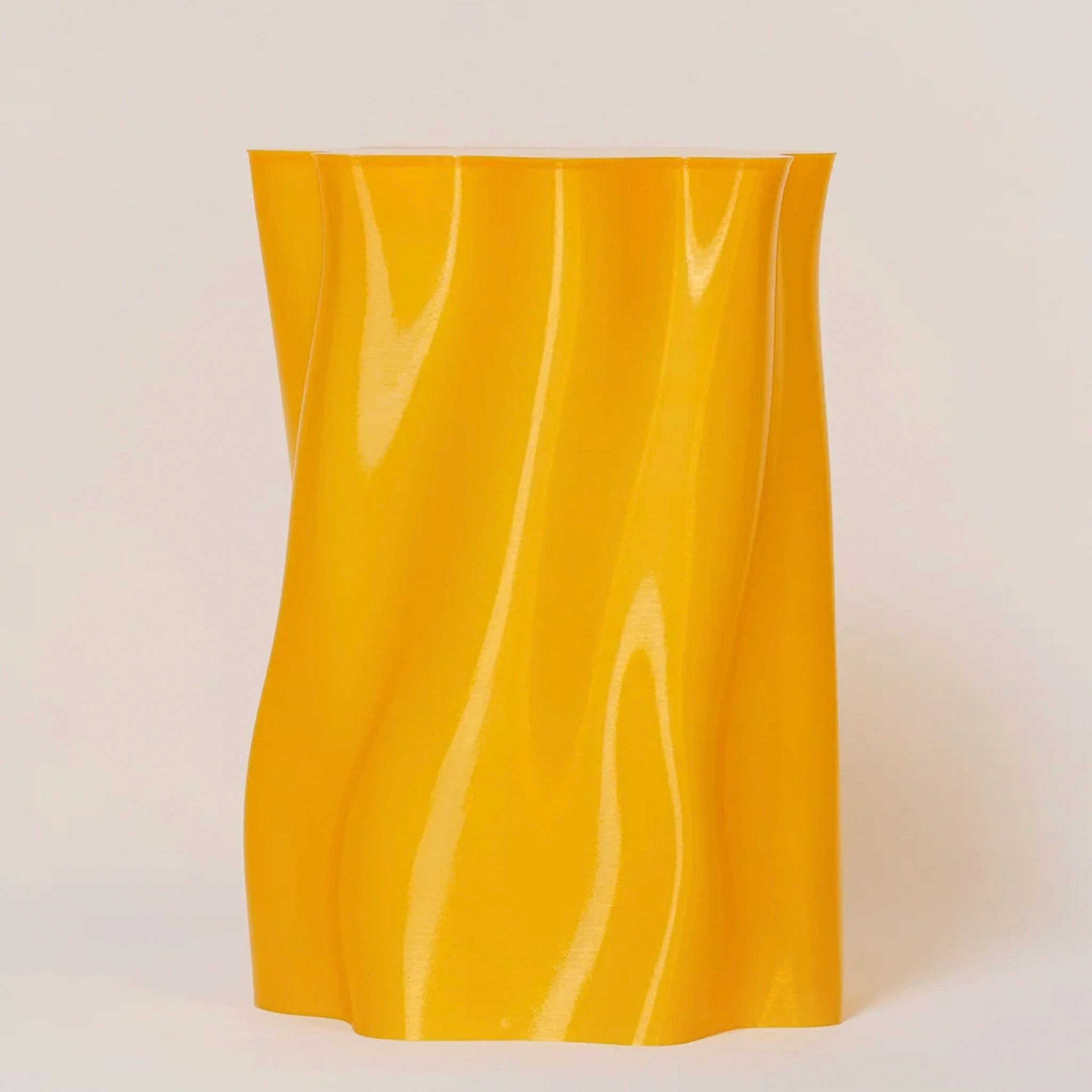 Yellow stool with wavy texture on a light beige background