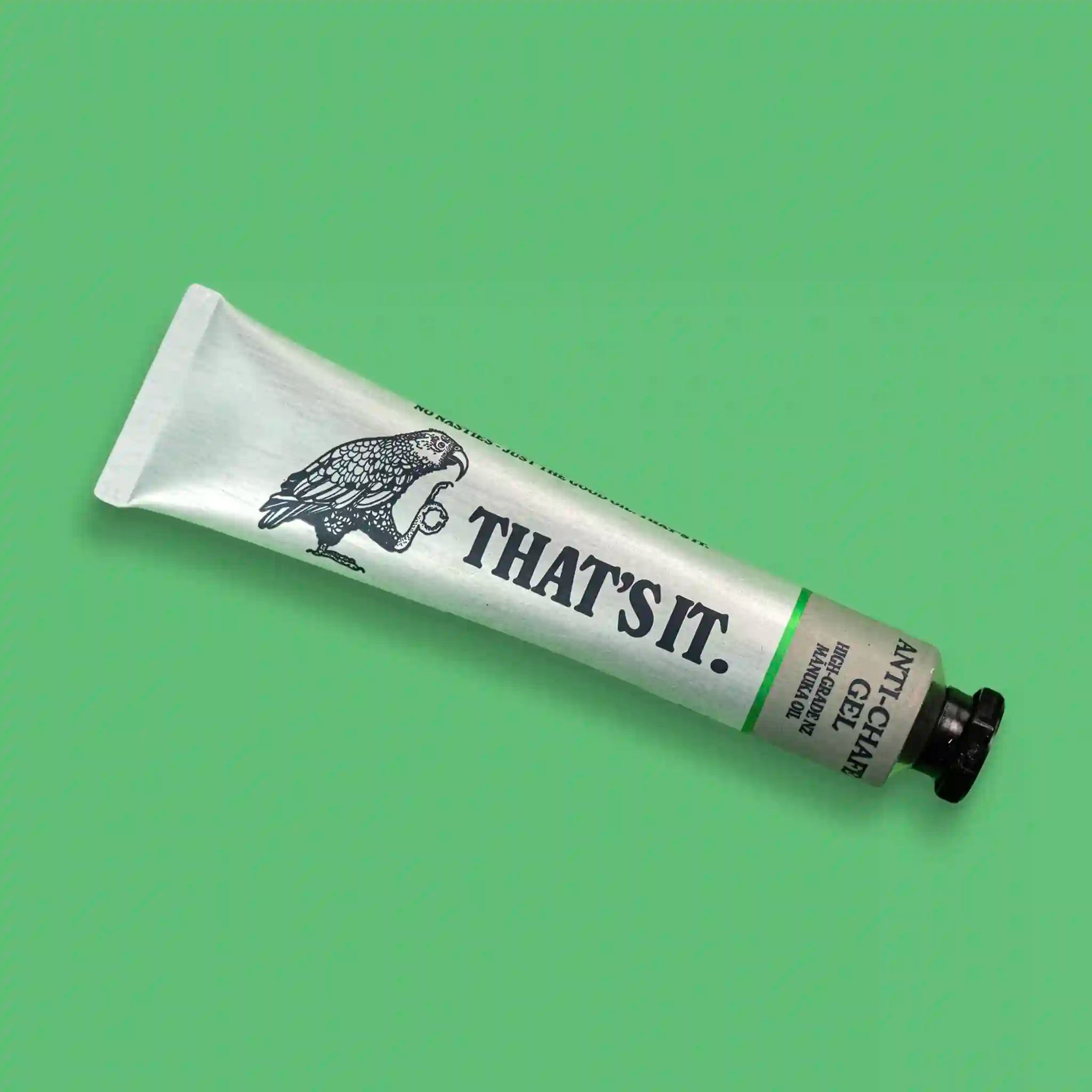 White tube with black text and a logo on a green background