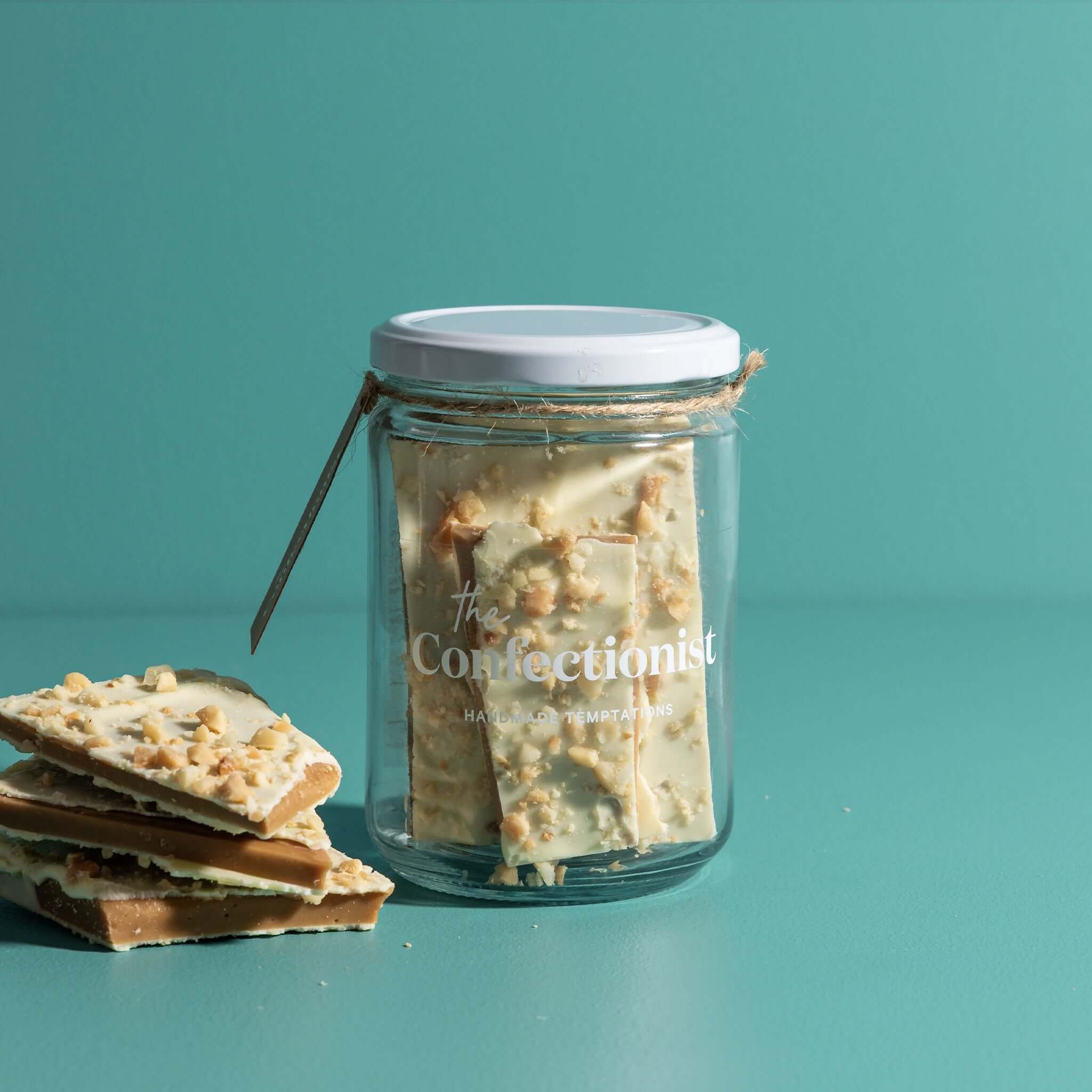 The Confectionist Limited Edition White Chocolate, Macadamia & Lemon Toffee - Large in glass jar with toffee pieces