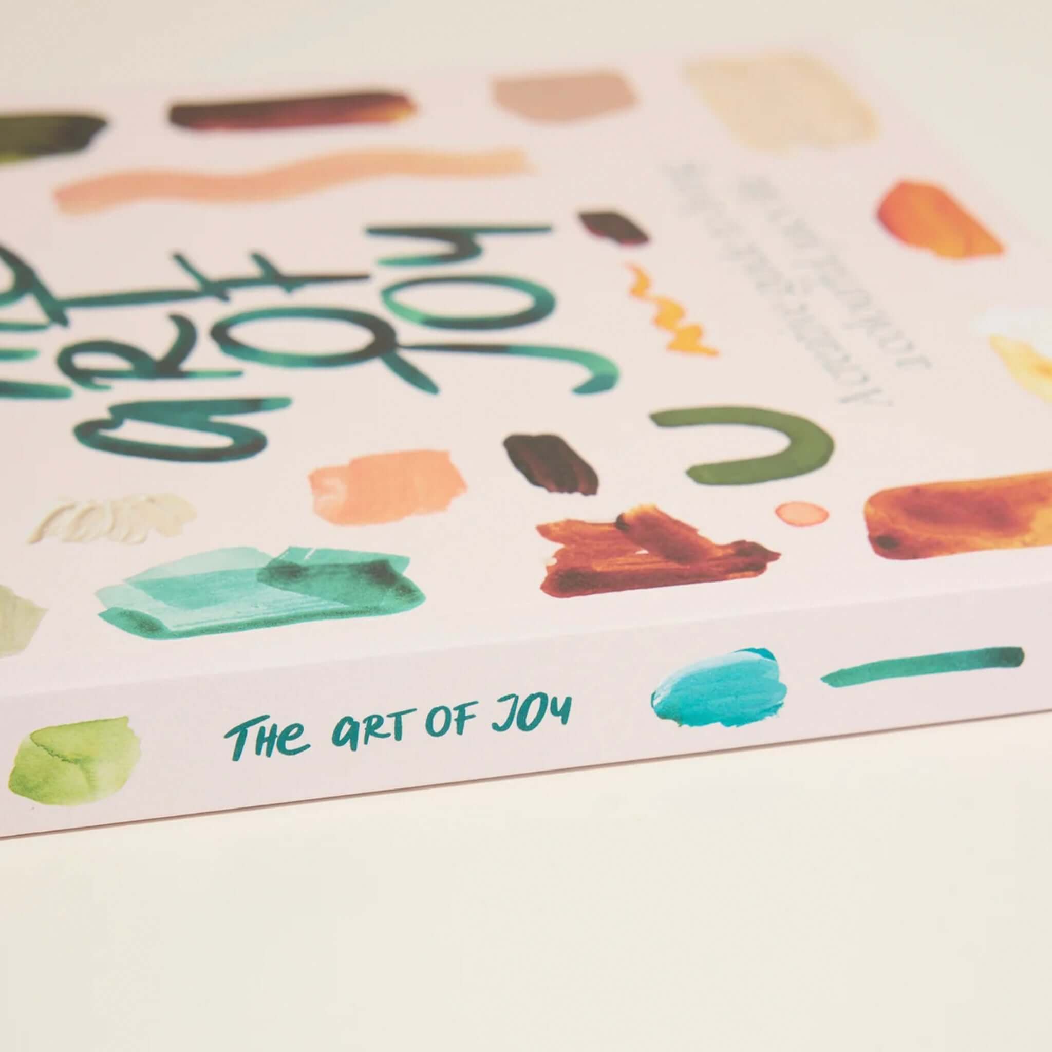 Alt Tag: The Art of Joy: Easy Daily Rituals and Practices for a Wonder Filled Life book cover with colorful paint swatches