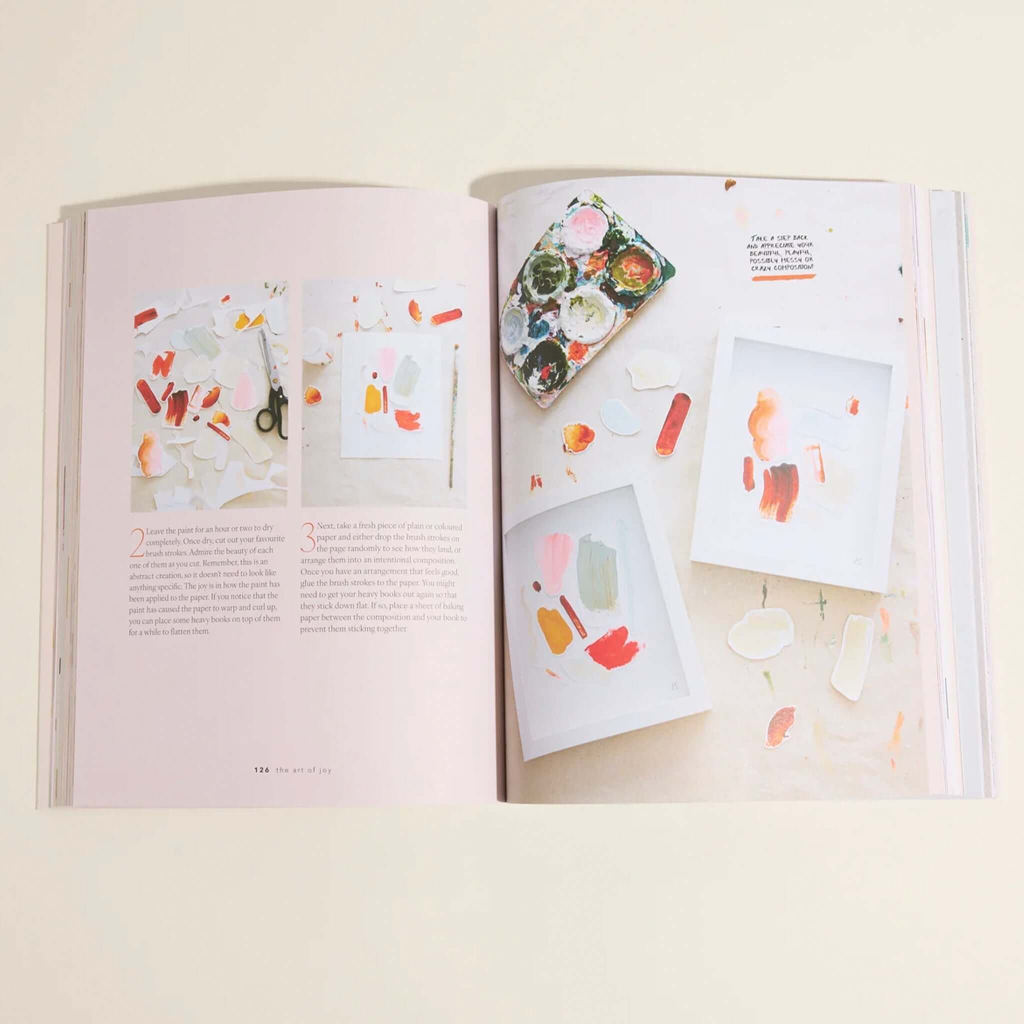 Alt Tag: Open book spread from The Art of Joy: Easy Daily Rituals and Practices for a Wonder Filled Life with watercolor palette and art pages