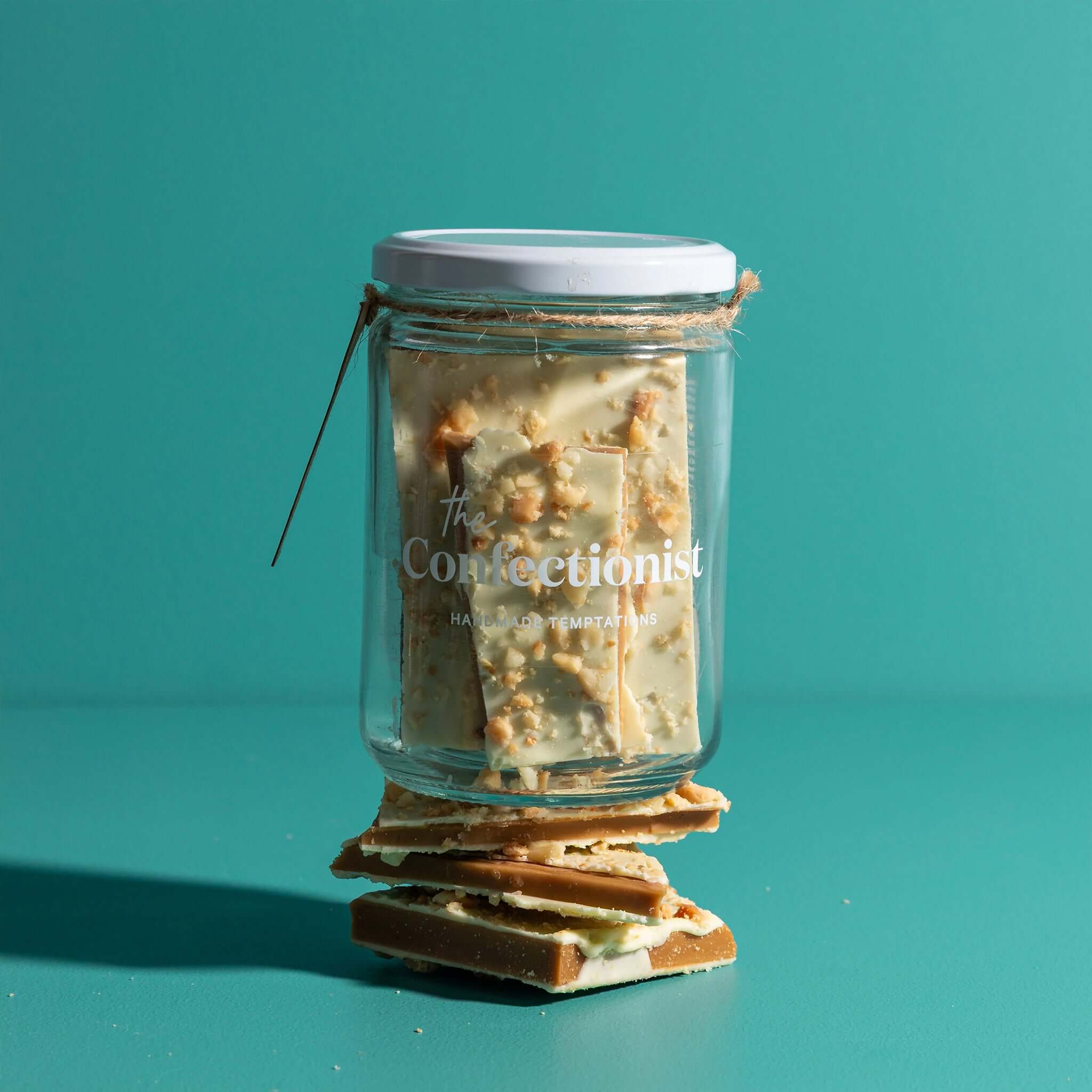 The Confectionist Limited Edition White Chocolate, Macadamia & Lemon Toffee - Large in a glass jar.