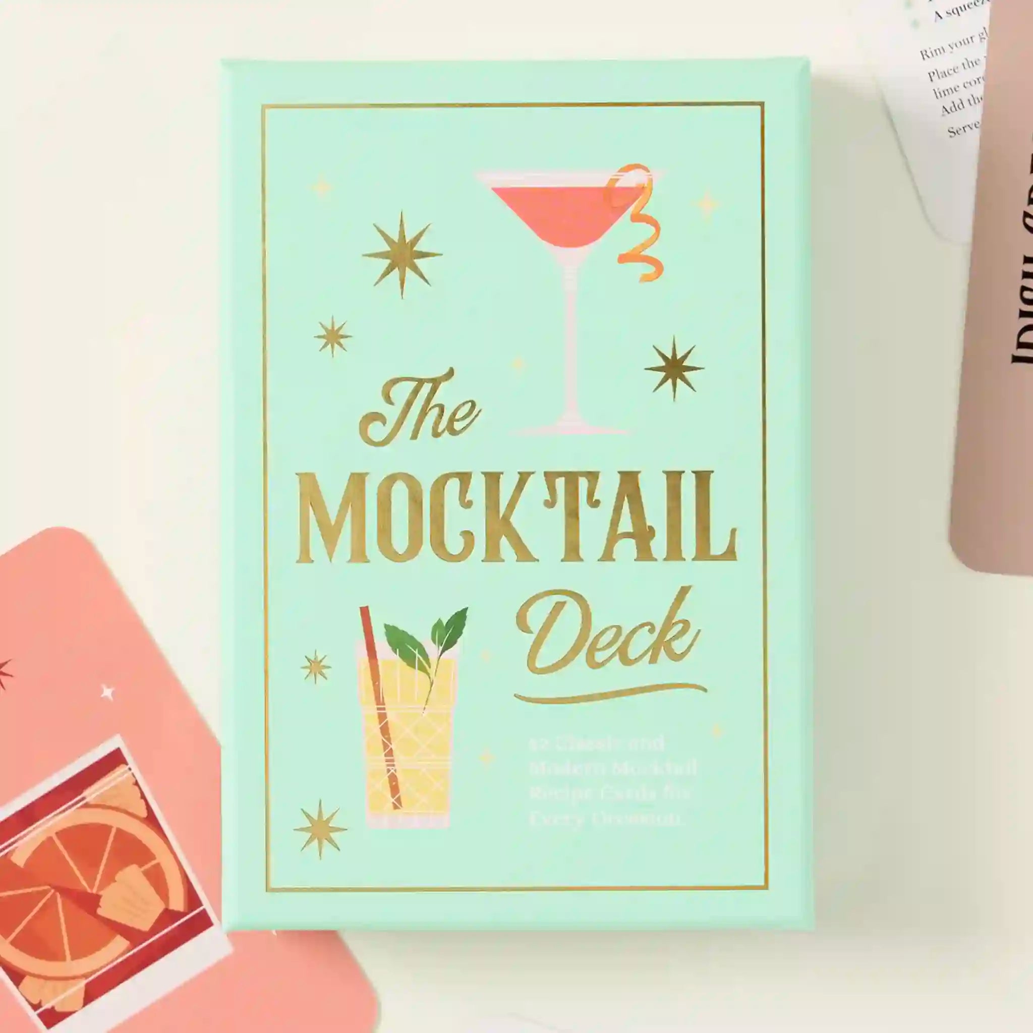 Card deck titled 'The Mocktail Deck' with cocktail illustrations on a light background