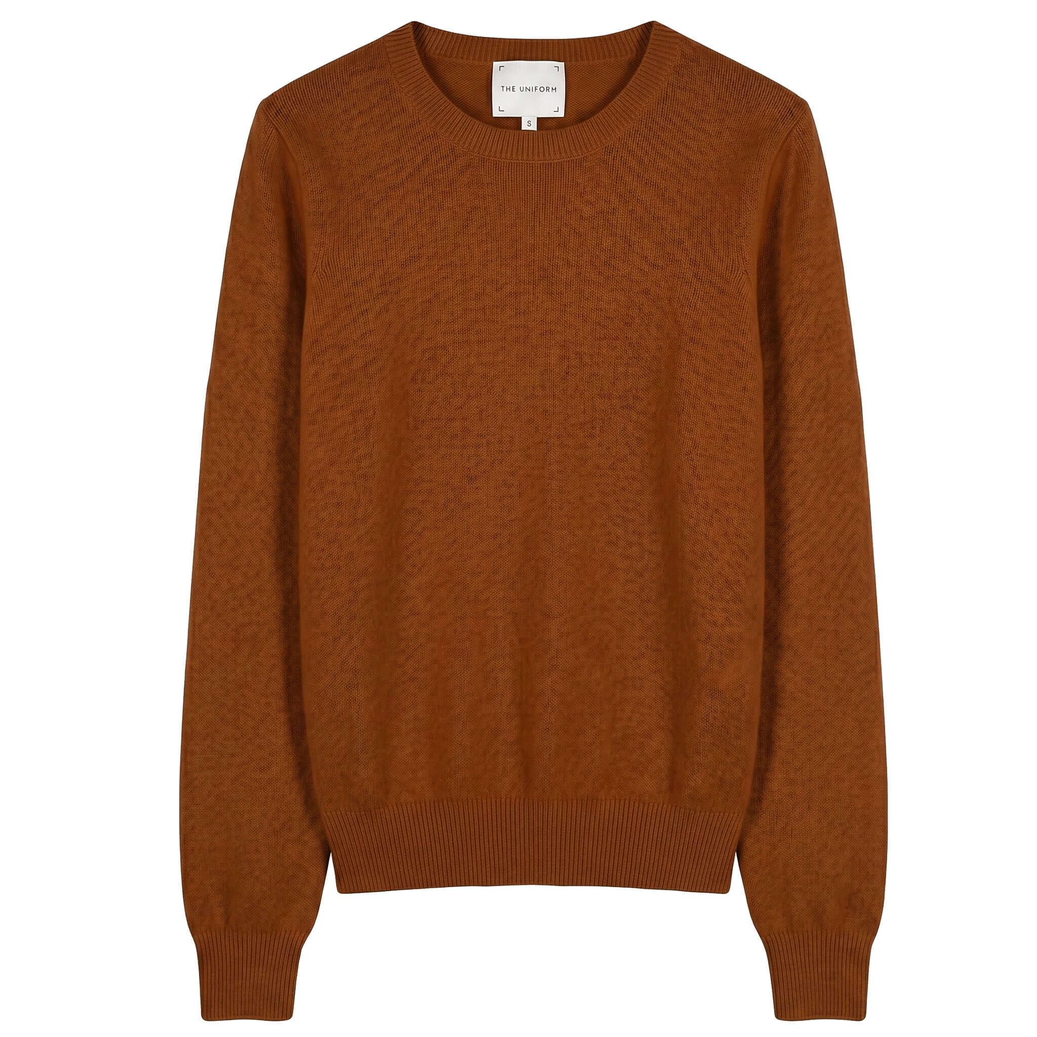 The Uniform Cashmere Crew Neck Sweater - Saddle in a rich brown color with a ribbed neckline and cuffs.