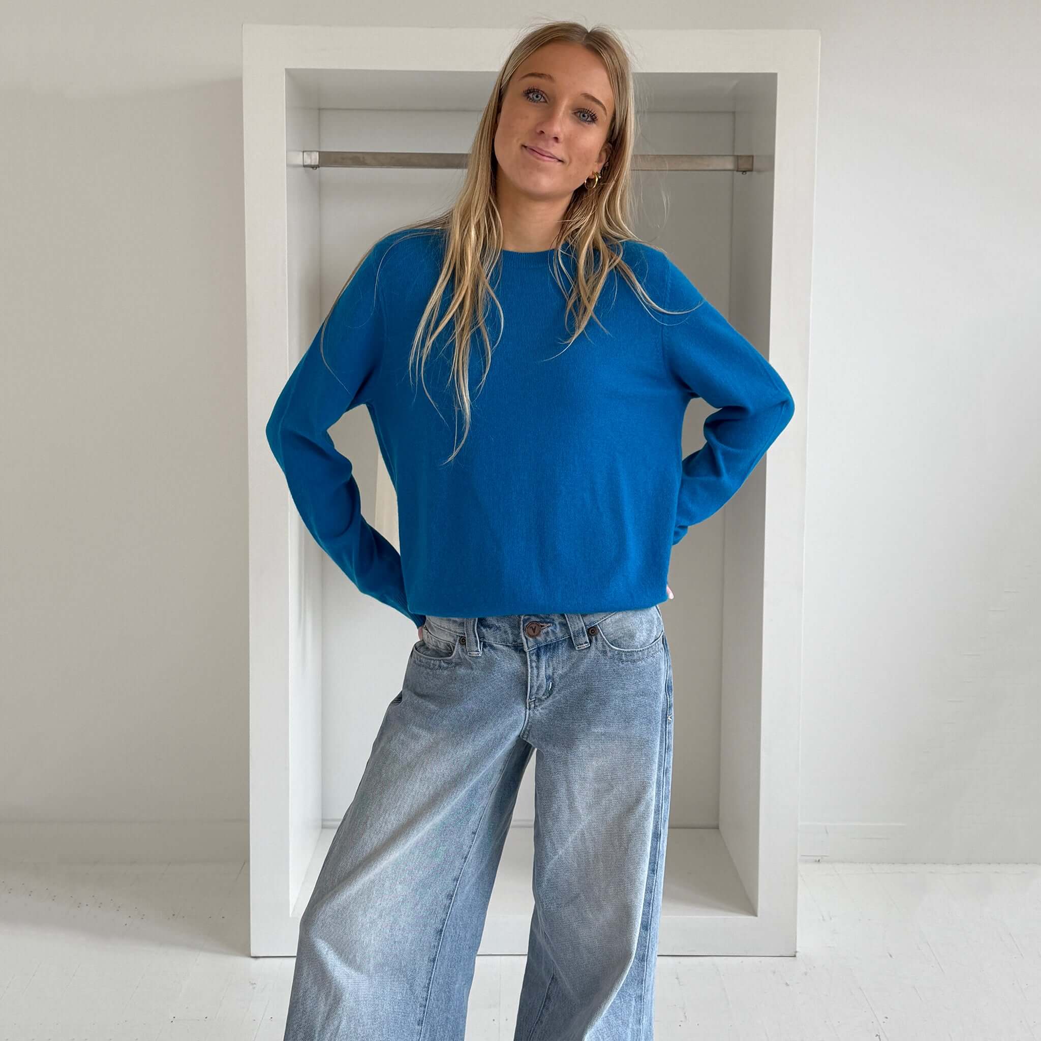 The Uniform Cashmere Crew Neck Sweater - Sapphire worn by model, showcasing relaxed fit and vibrant sapphire color.