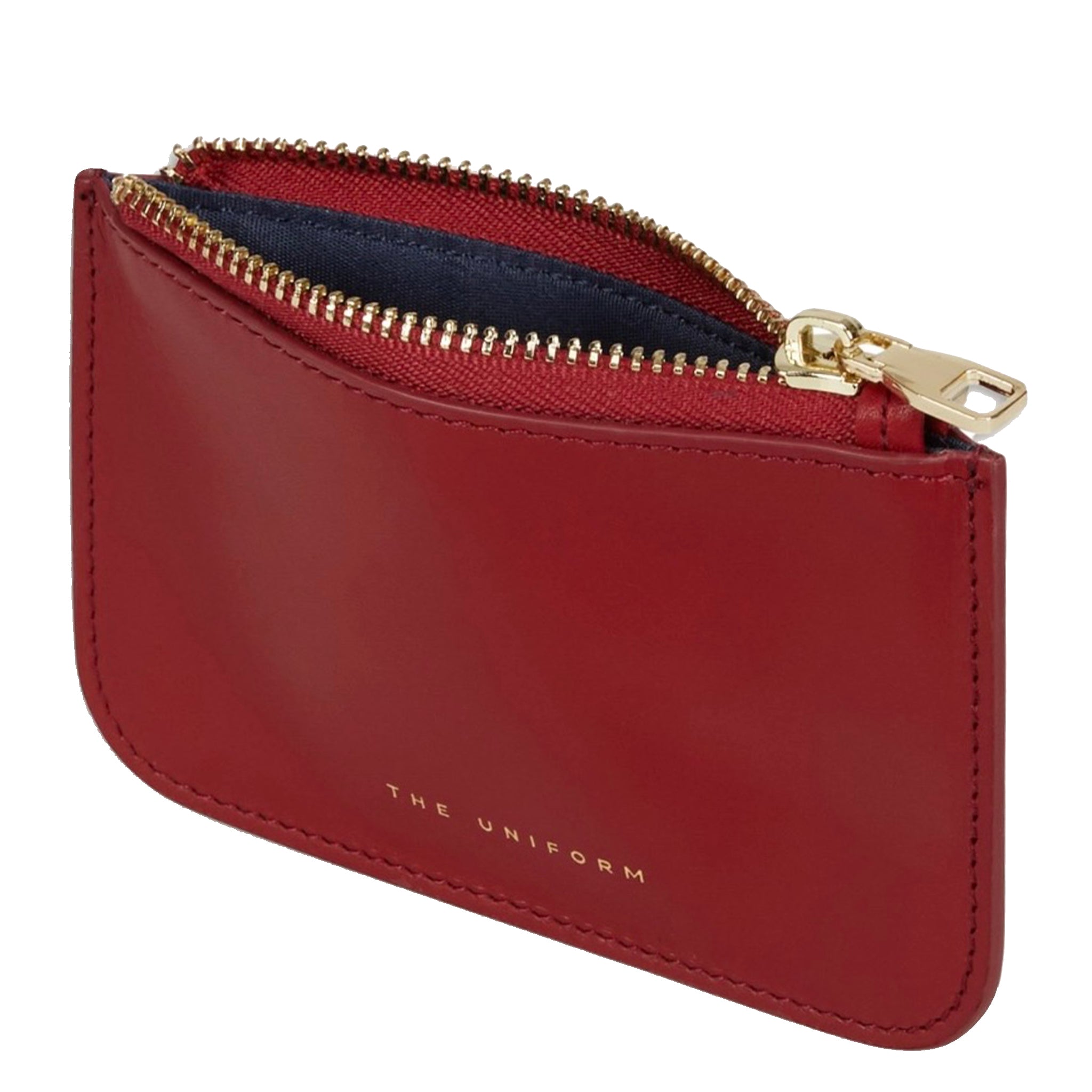 A red leather zippered card holder pouch with gold-tone hardware and the brand name 'THE UNIFORM' debossed on the front, shown against a plain white background.