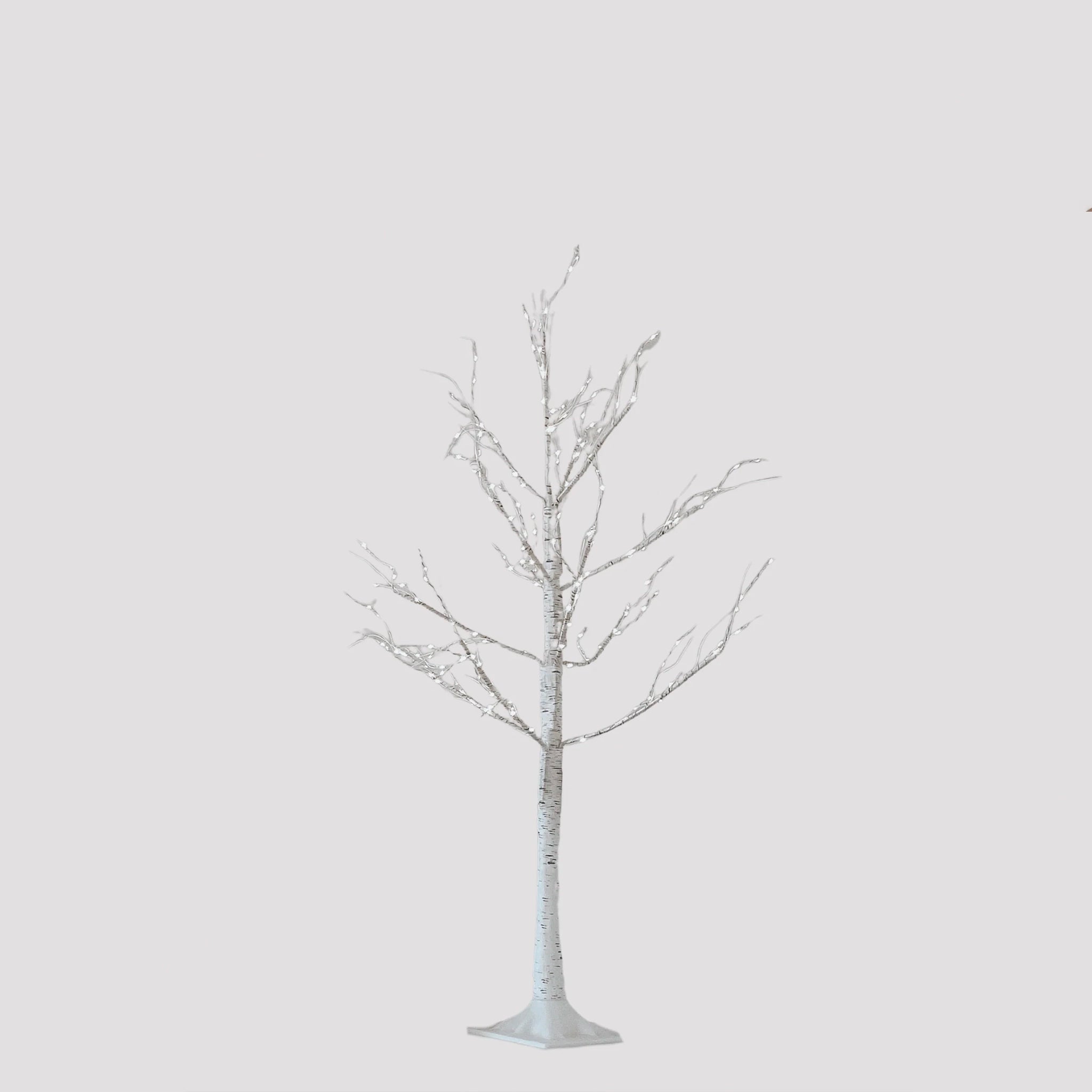 Artificial white birch tree on a light gray background