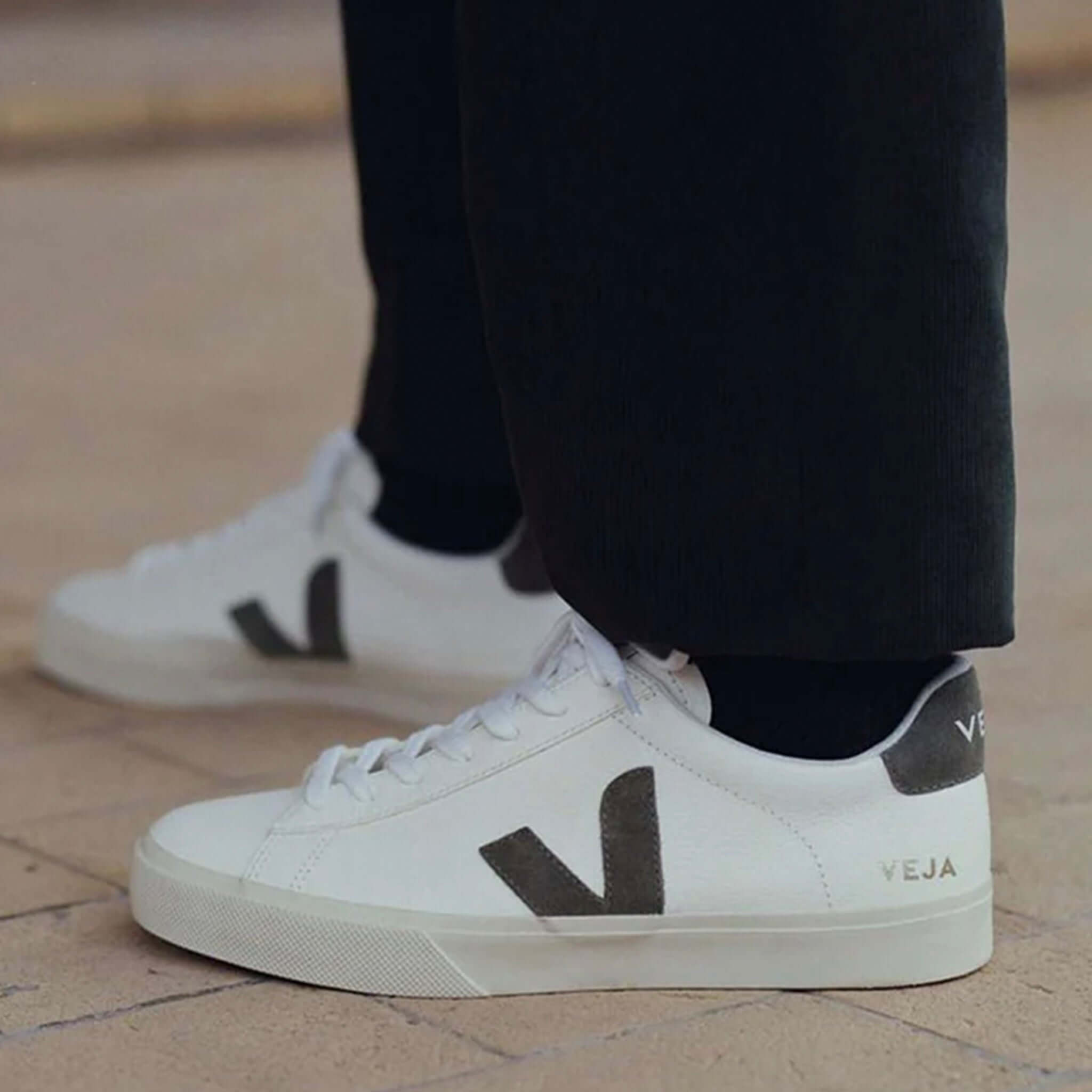 Alt Tag: Veja Campo Women's Leather Sneakers - Extra White, Khaki Suede worn with black pants, side view of sustainable ChromeFree leather sneaker