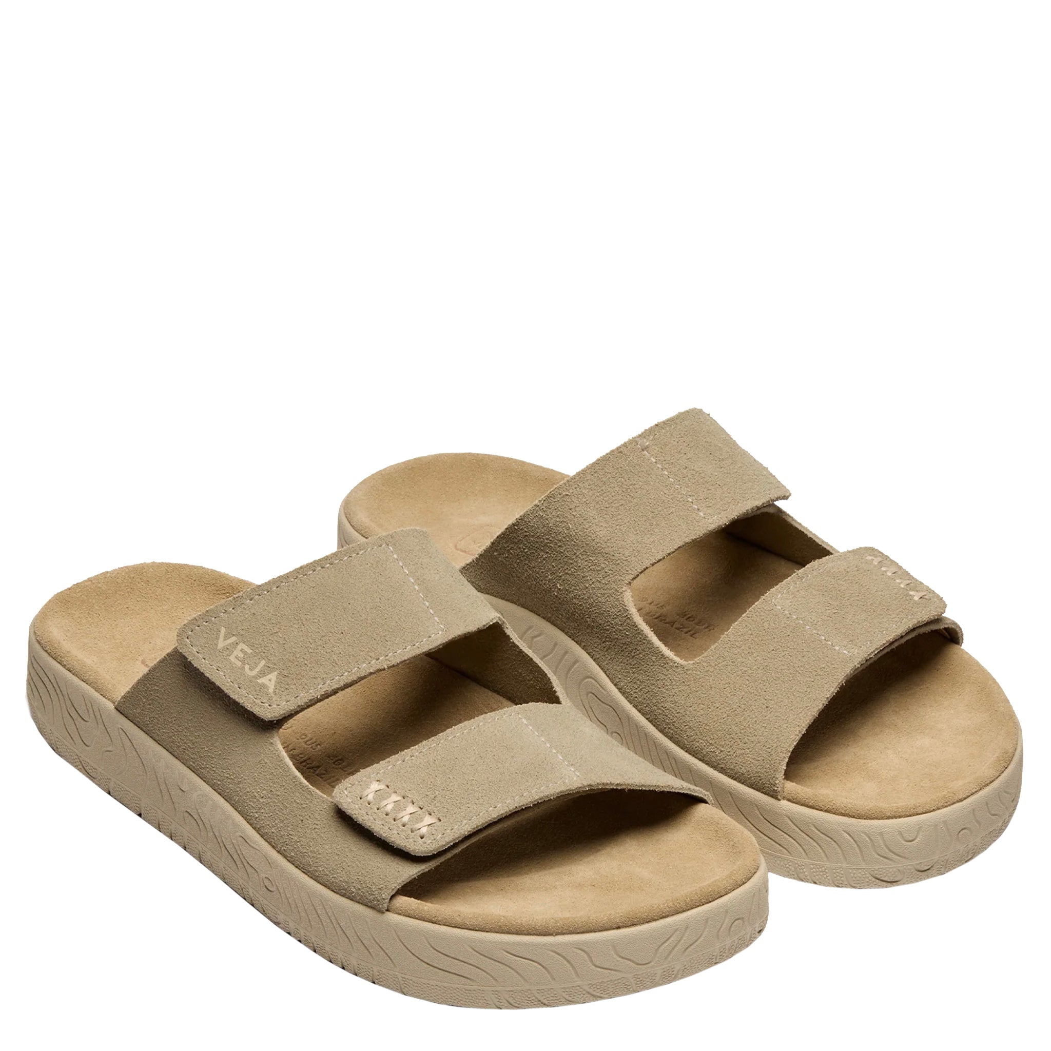 Beige sandals with velcro straps on a white background