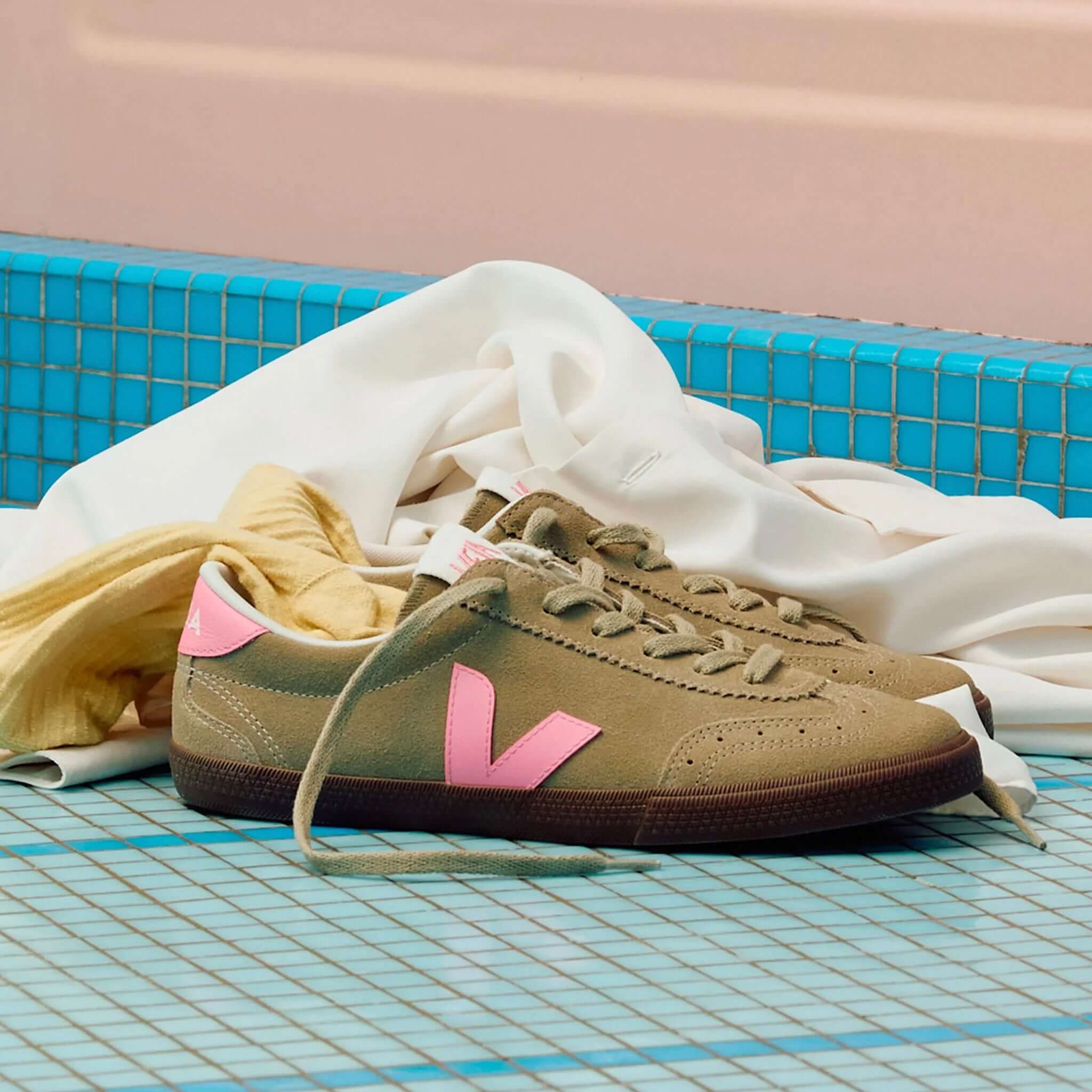 Veja Volley Suede Sneakers - Taupe, Malibu & Bark displayed on a tiled surface with draped fabric.