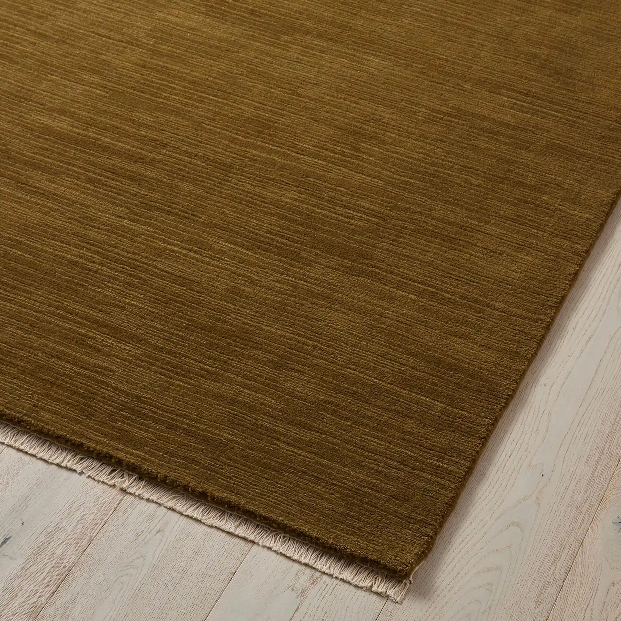 Brown rug on a light wood floor